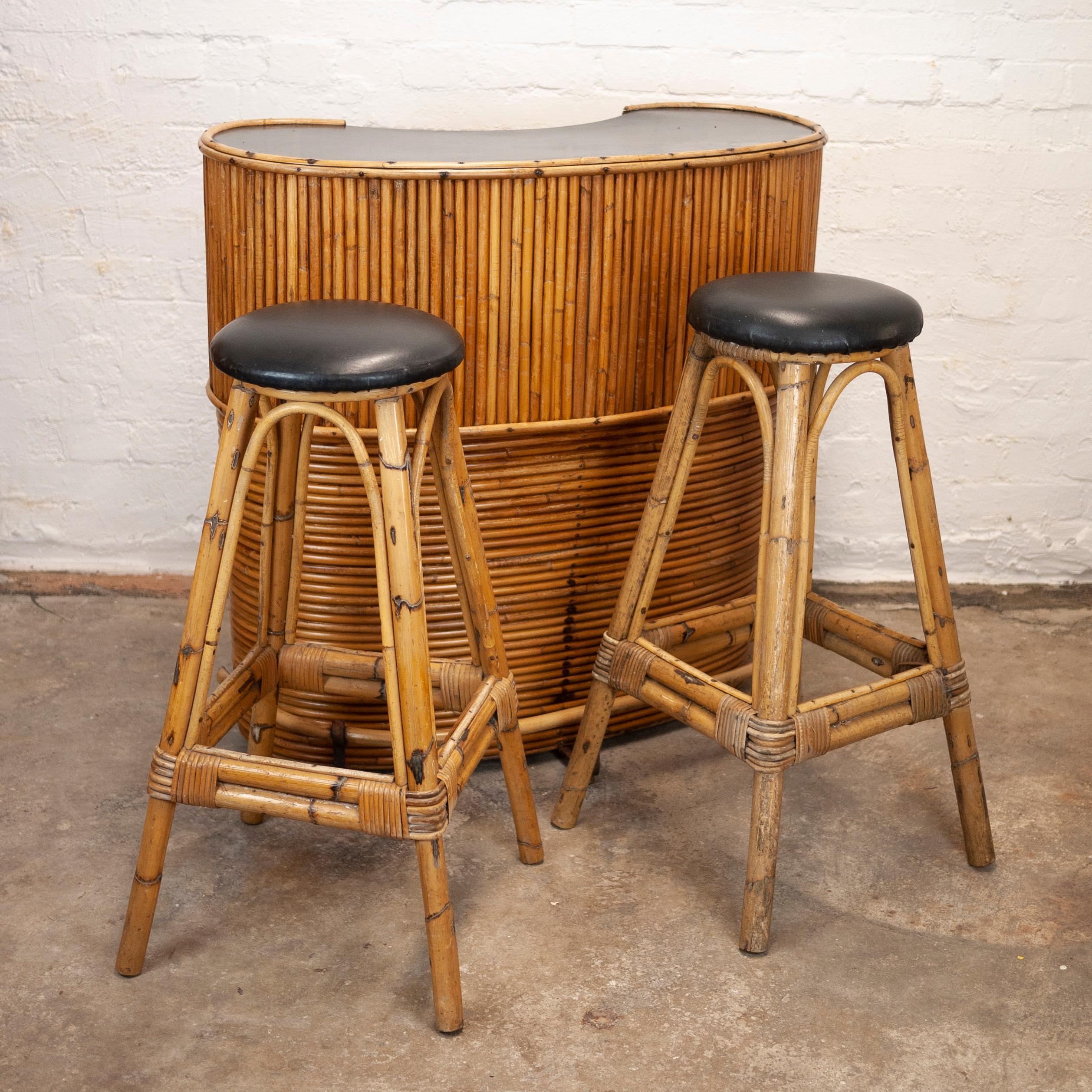 A vintage bamboo tiki bar and 2 stools from the 1960s.

Design Period - 1960 to 1969

Country of Manufacture - France

Style - mid-century

Detailed condition - good with minimal defects. Stool seats show wear which is visible in