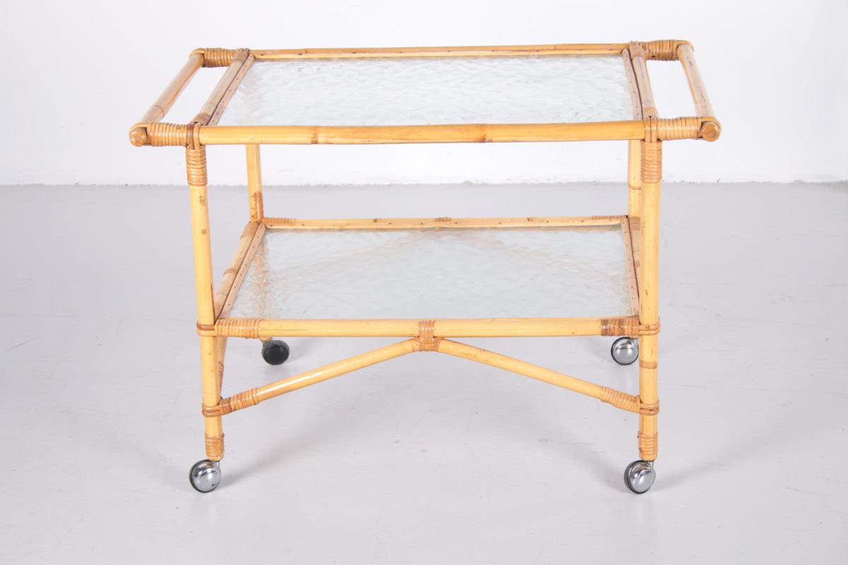 Vintage Bamboo Trolley and Serving Trolley, 1960s

This beautiful vintage rattan/bamboo drinks trolley is typical of the 60s and combines perfectly with both vintage and new designs.

The trolley comes from Denmark.
Its shape is original, with two