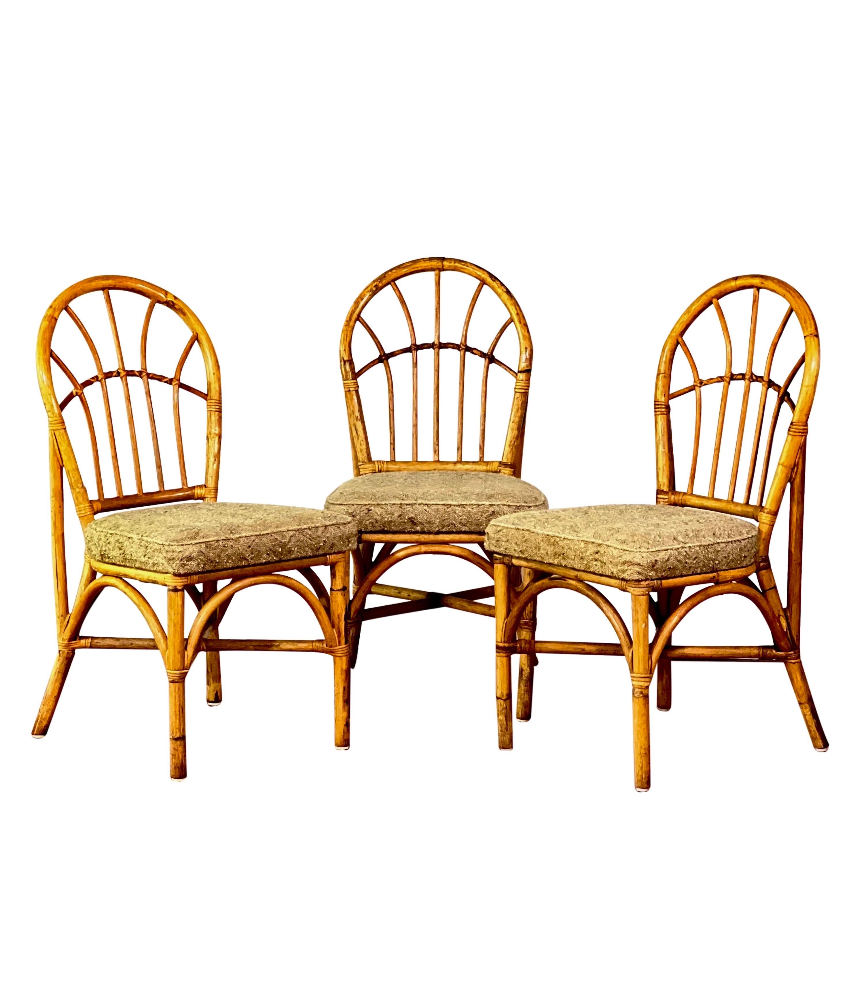 Set of 4 vintage bamboo upholstered dining chairs, 1960s.

Chairs are upholstered in a textured herringbone pattern wool in a neutral oatmeal color. The cushions are attached to the frame and in good condition with no tears, rips or stains. All
