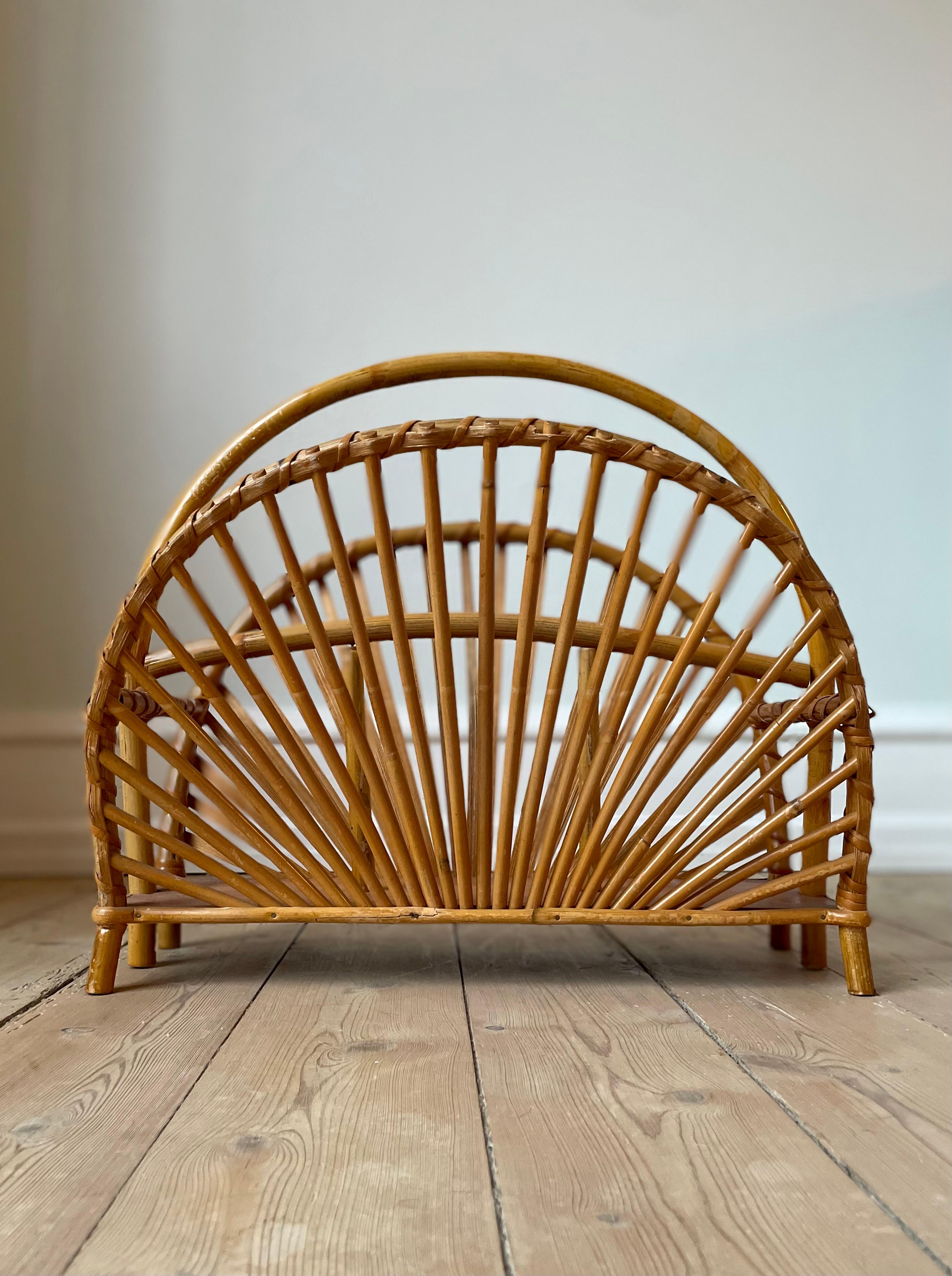 Vintage organic modern magazine rack in natural materials. Semi-circular shape with slender bars, large handle and wooden base on six feet. 
Beautiful vintage condition. 
Scandinavia, circa 1960s.