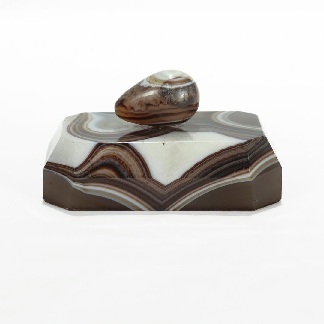 A fine mineral specimen paperweight or curio.

In the form of a small polished agate egg on a geometric banded agate base.

Perfect for the desk or Grand Tour Wunderkammer!

Date:
20th Century

Overall Condition:
It is in overall good, as-pictured,