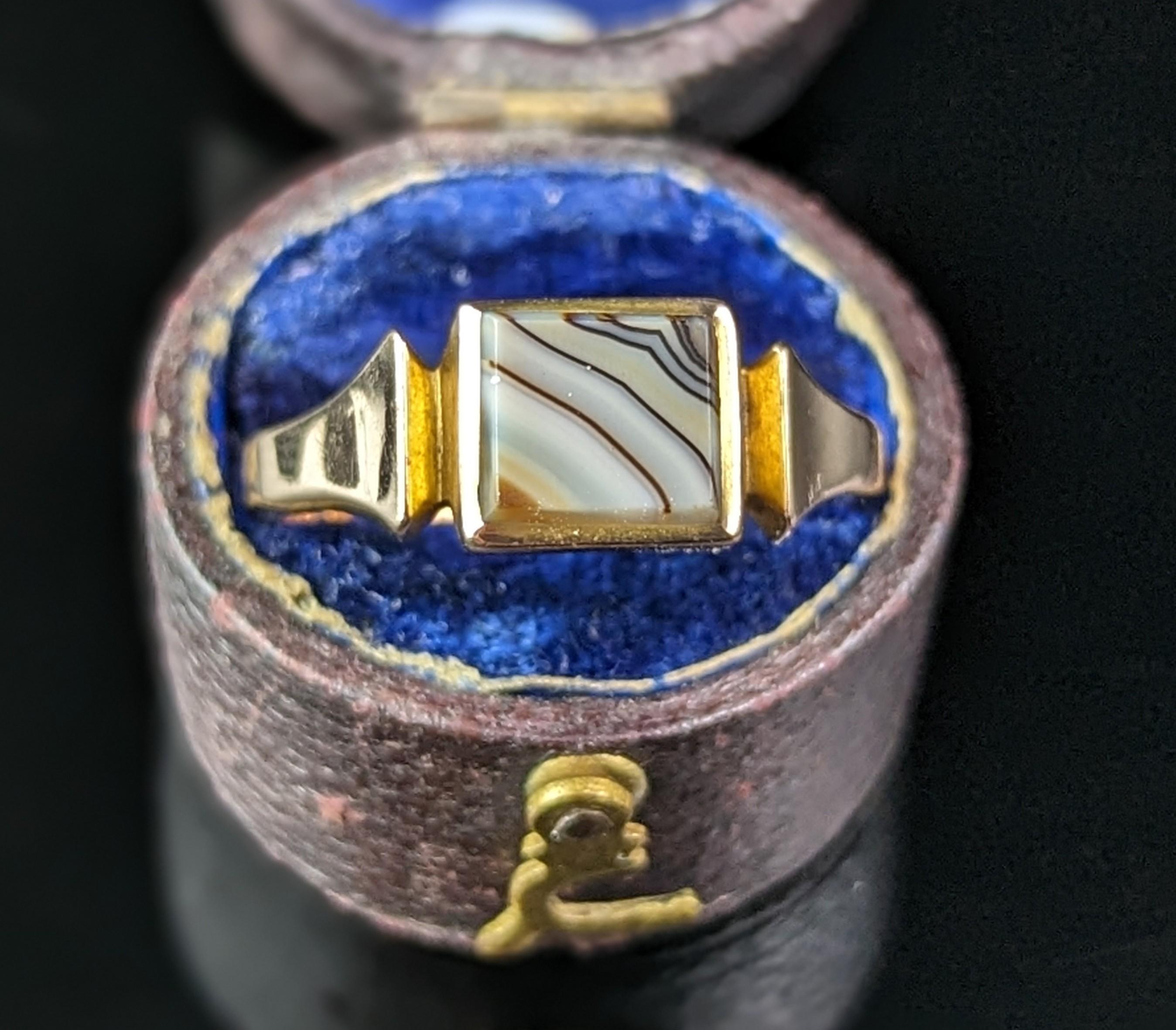 If you are looking for a classy vintage signet ring then this one is for you.

A simple yet handsome design, this signet ring has a smooth square shaped face set with a square shaped banded agate.

It has a smooth polished band and a deep recess at