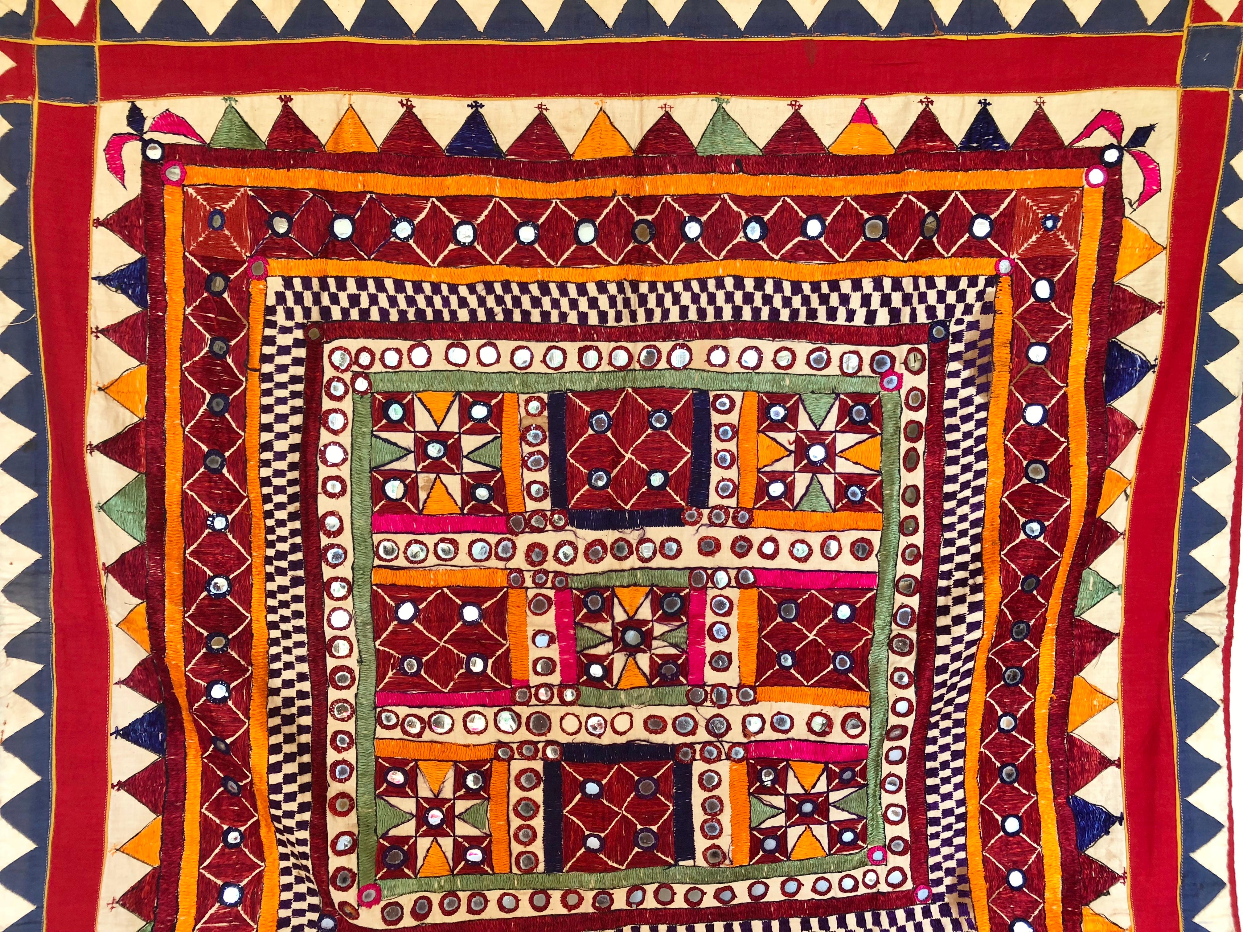 Vintage Banjara tribal embroidered Chaakla textile wall decor from India. Handwoven cotton base cloth embellished with mirrors and hand embroidery work. Textile art. This piece was made for personal use, not the tourist trade, so it shows some