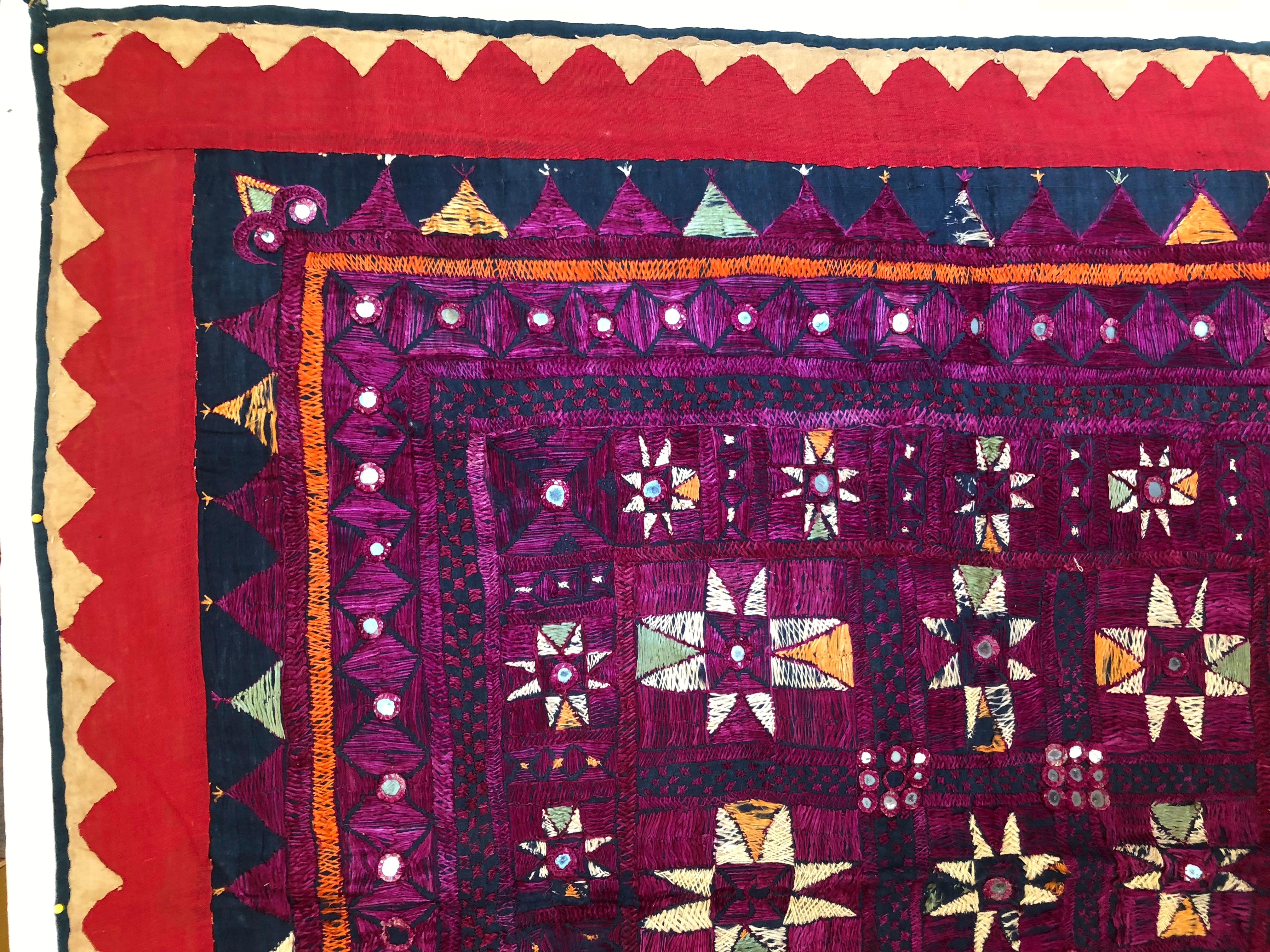 Vintage Banjara tribal Chaakla textile wall decor, India. Handwoven base cloth is embellished with hand embroidery work and mirrors, Textile art. This piece was made for personal use, not the tourist trade so it shows some thread loss and wear.