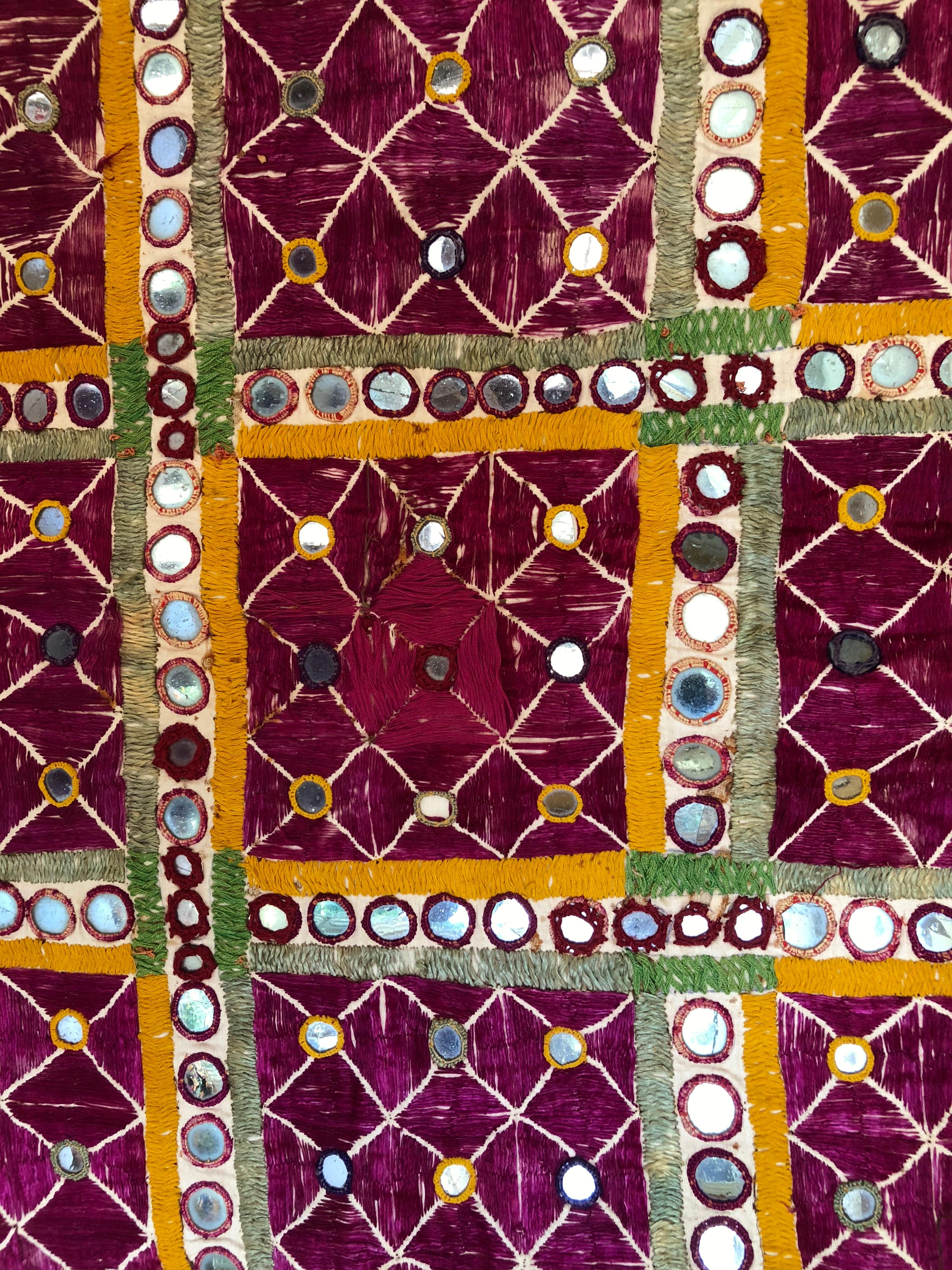 Vintage Banjara tribal Chaakla textile wall decor, India. Handwoven base cloth is embellished with mirrors and hand embroidery work. Textile art. This piece was made for personal use, not the tourist trade so it shows some thread loss and wear.