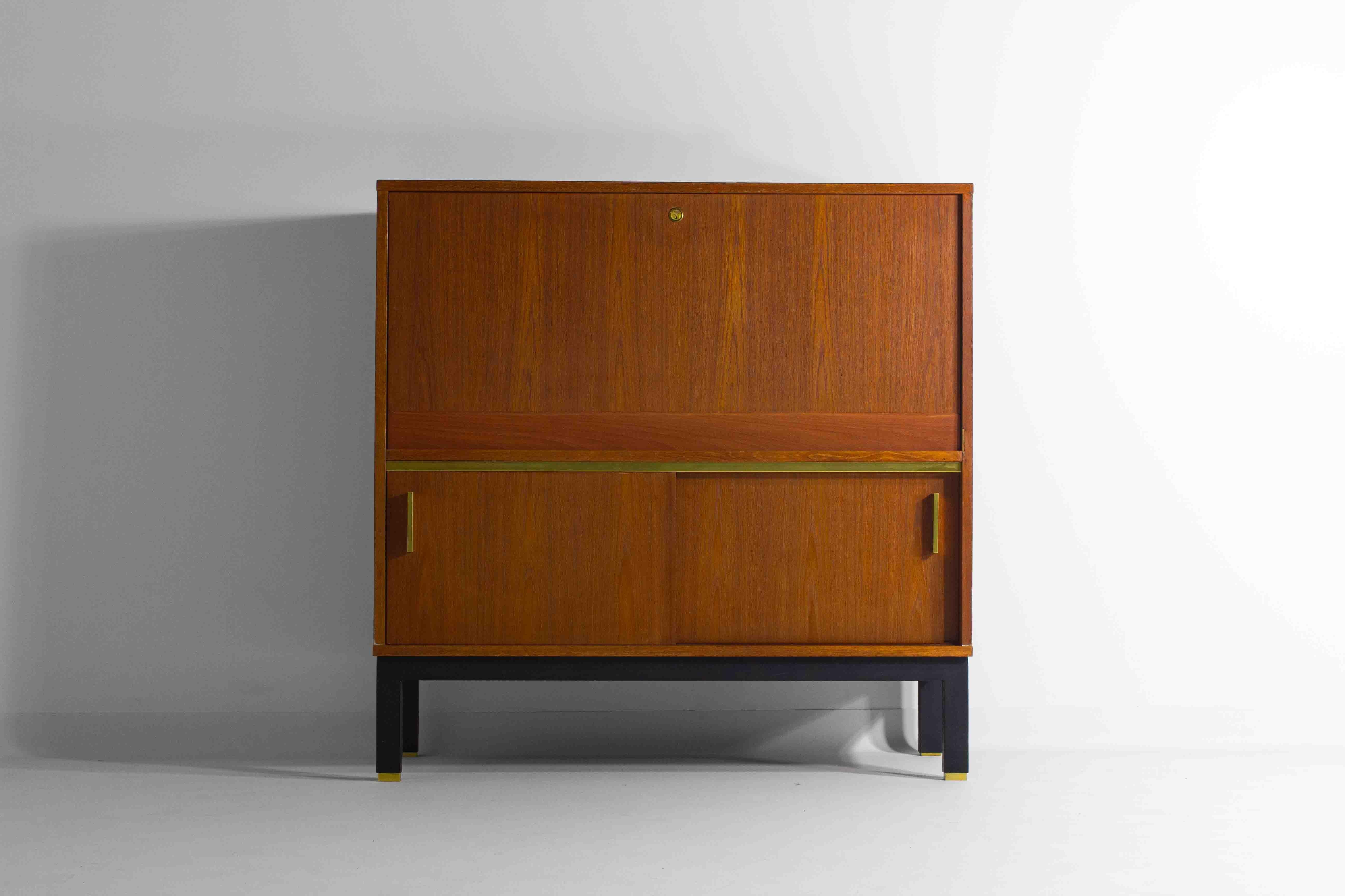 Mid-century modern bar cabinet in premium teak wood adorned with stunning golden details. We have a matching sideboard available from the same set.