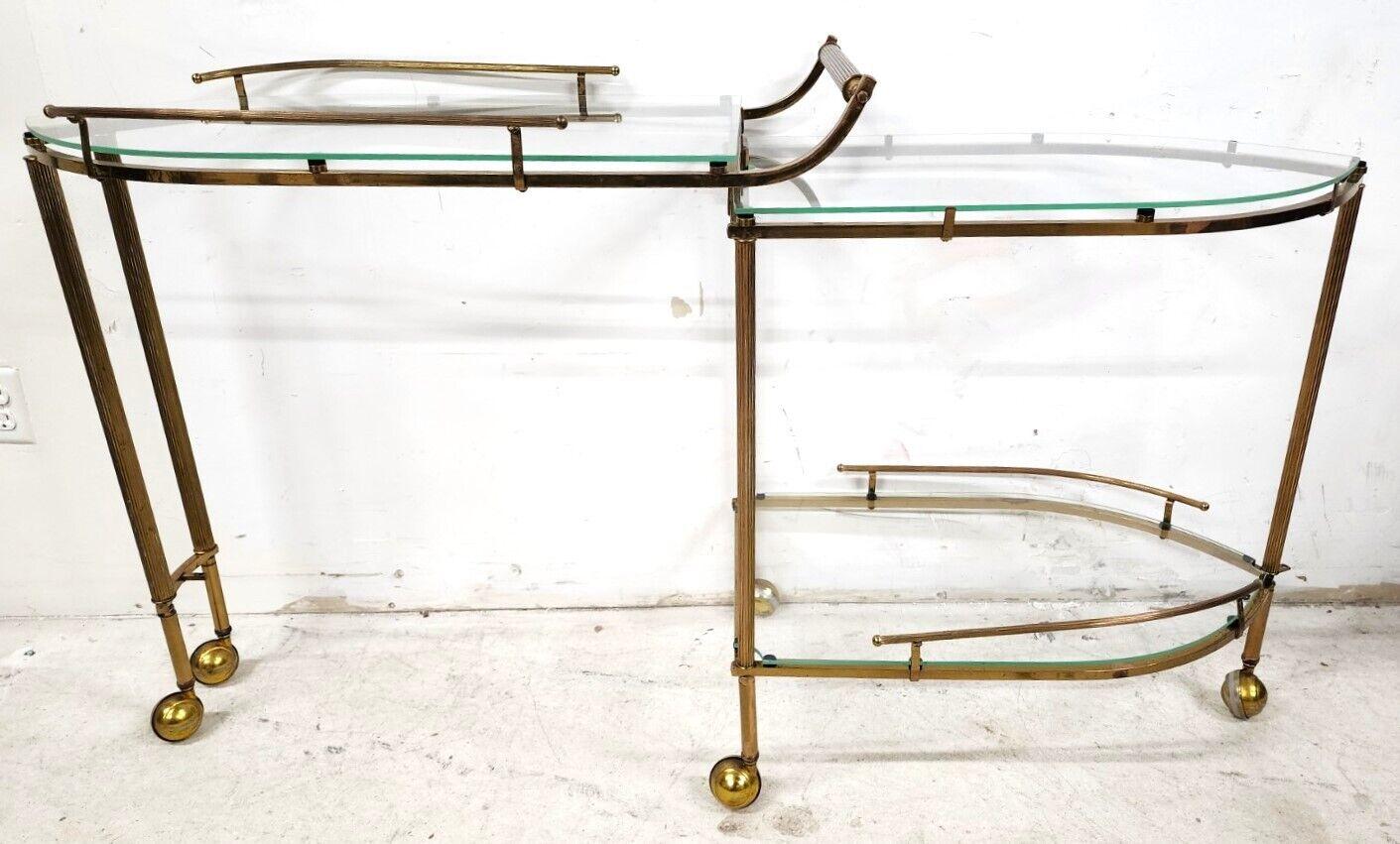 Offering one of our recent palm beach estate fine furniture acquisitions of a 
Vintage expandable brass & glass rolling 3 tier bar tea serving cart 


Approximate measurements in inches
33