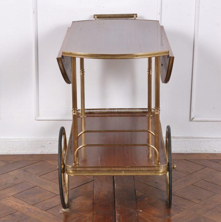 Vintage bar cart in mahogany veneer and brass. With lower shelf for bottles, etc. On original large wheels and casters.

30 inches Wide (Open) x 17.5 inches Wide (Closed) x 32.5 inches Deep x 28 inches Tall.

  