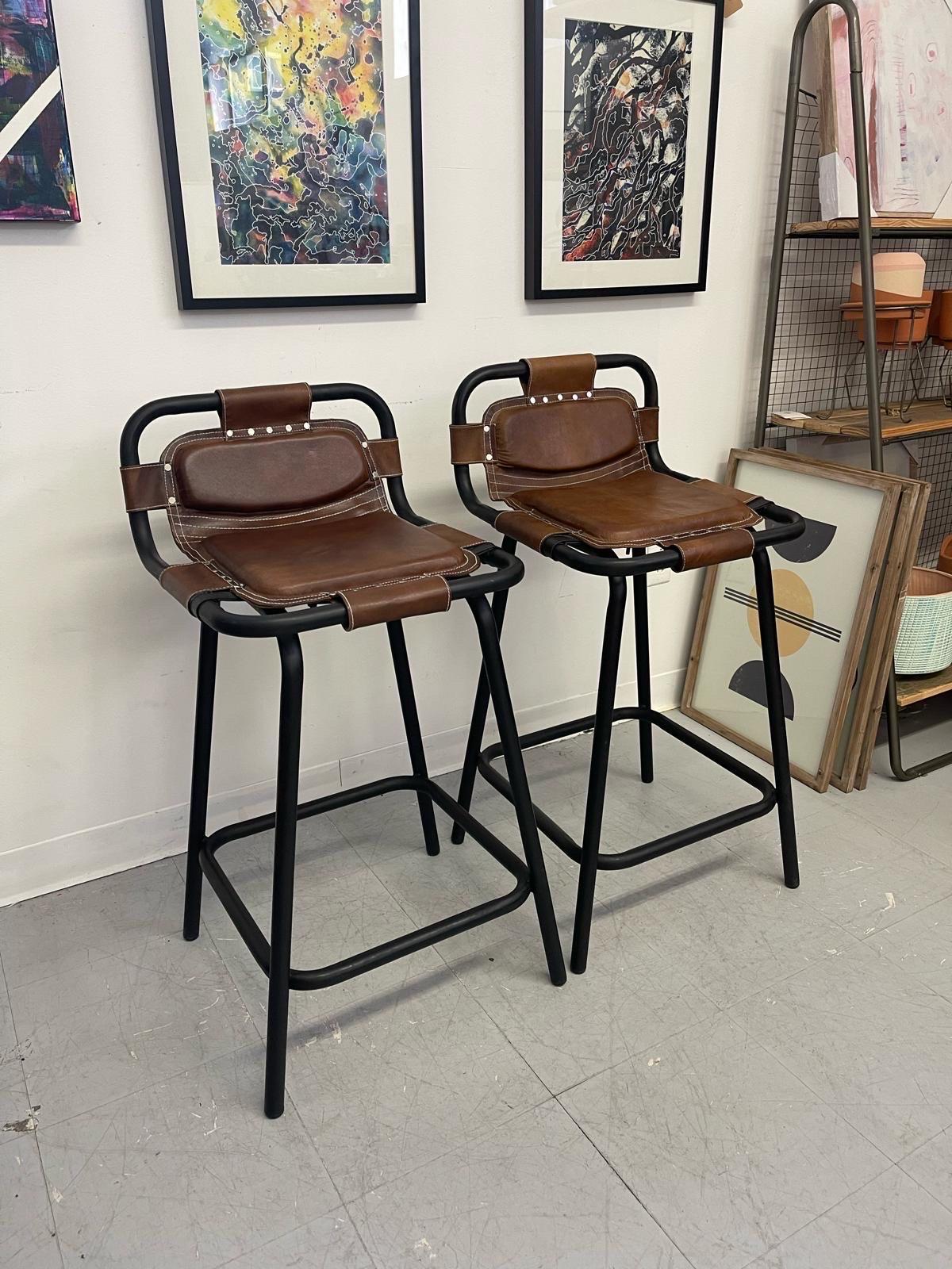 Counter Height Stool with Cushioned Leather Seat. Features Black Metal Frame with Foot Rest. White Stitching contacts the Brown Leather Seating. Based off Mid Century Design.

Dimensions. 20 W ; 14 D ; 36 H
Seat Height 27