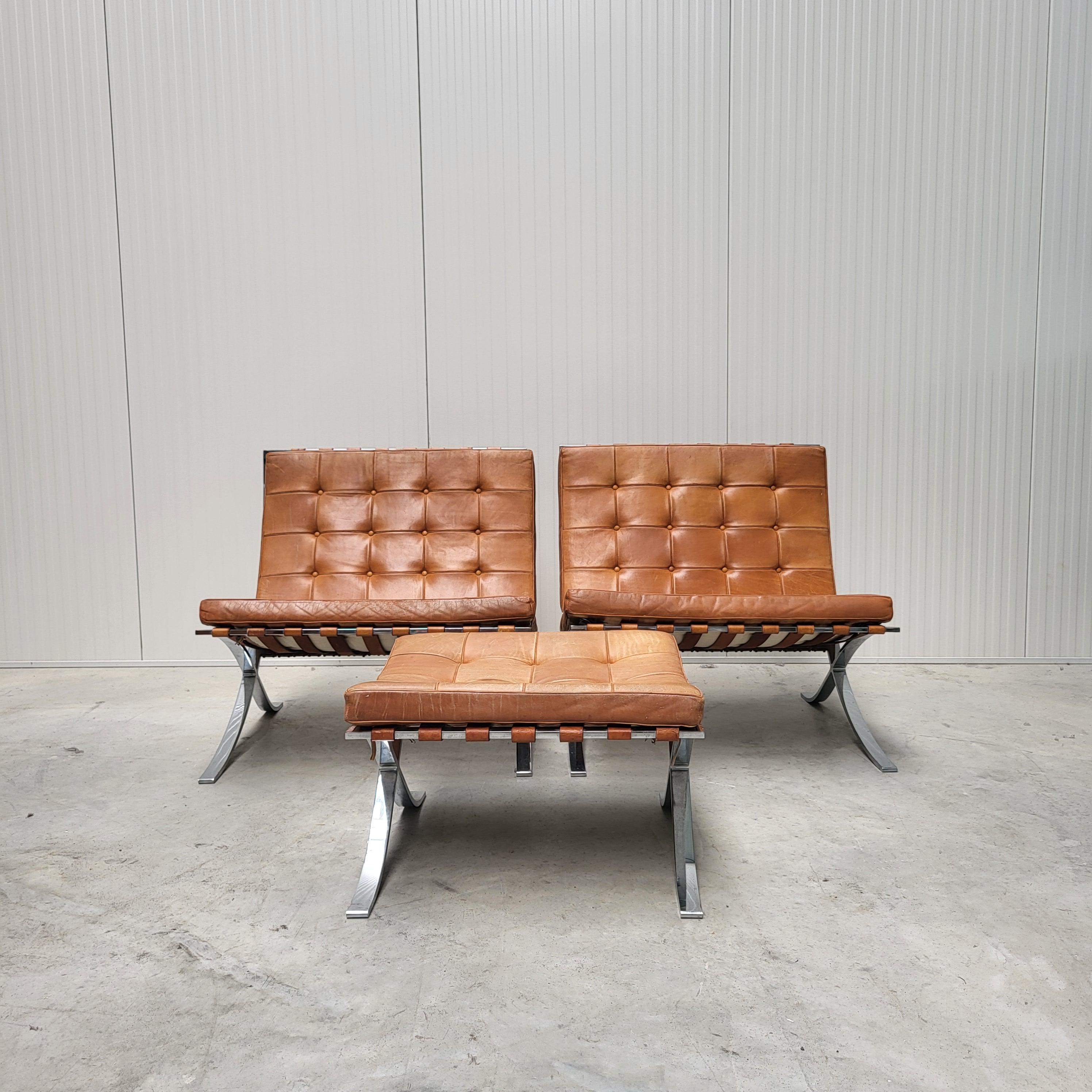 This rare set of Barcelona chairs with an ottoman was designed by Mies van der Rohe in 1929 and produced by Knoll in the 1960s. 

The pieces features an amazing hand dyed cognac leather upholstery with on a chromed steel base. 

The Barcelona chairs