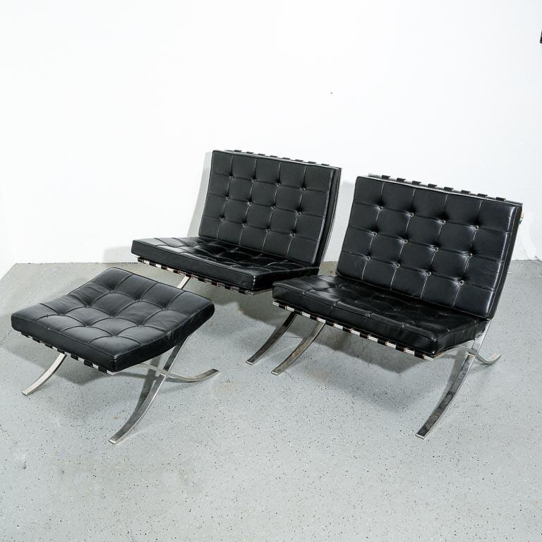 Vintage Barcelona Lounge Chairs set with Ottoman designed by Ludwig Mies van der Rohe. 1950s Knoll production. Tufted black leather cushions over a swept steel bar frame. One seat cushion has been reupholstered. All pieces signed.

This set can be