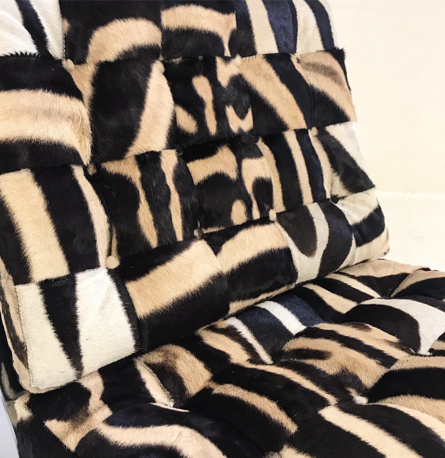 We collected this pair of chairs in the manner of the original Barcelona chair designed by Mies Van Der Rohe. Our master upholsterers created brand new seat and back cushions for the chairs fashioned from our zebra hides. Each square of zebra hide