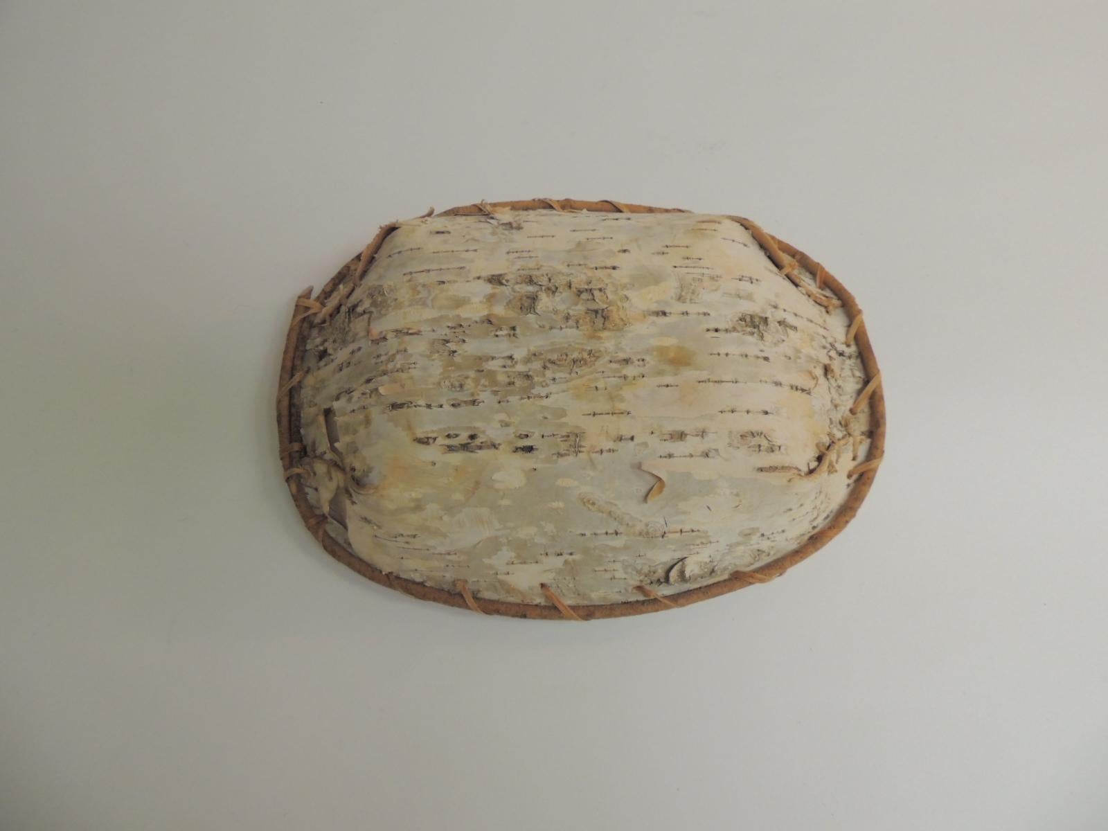 Vintage Primitive tree bark serving decorative artisanal bowl.
Decorative bowl handcrafted from the tree bark in oval shape natural color with bamboo rim and woven rattan detail. Artisanal style.
Canada, 1980s.
Size: 12 x 9 x 2.