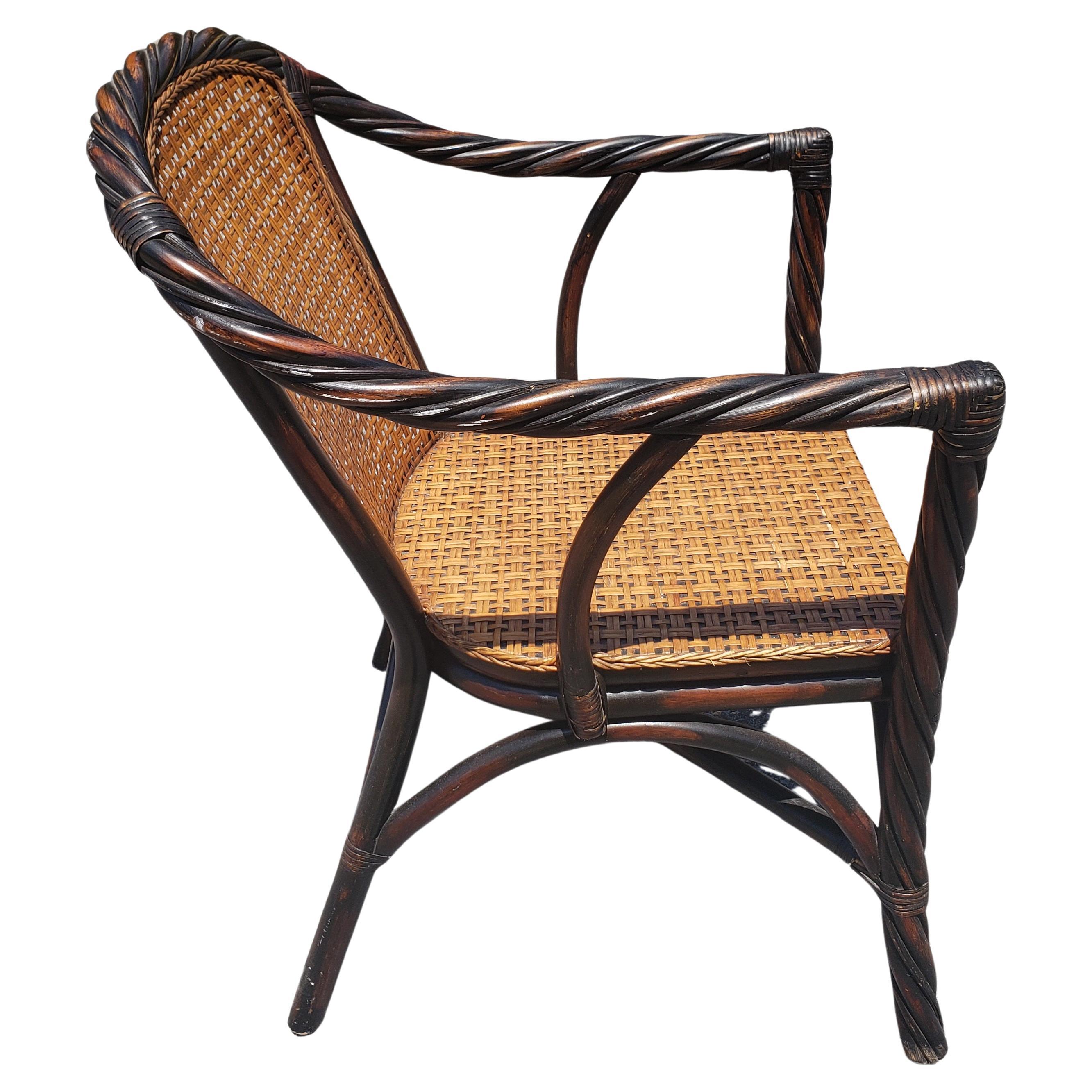 Vintage Barley Twist Ebonized Faux rattan and wicker seat and back armchair in very good vintage condition. Very solid woven wicker over wood seat and back. Very nicely ebonized with patina. Measures arm height is 27.5
