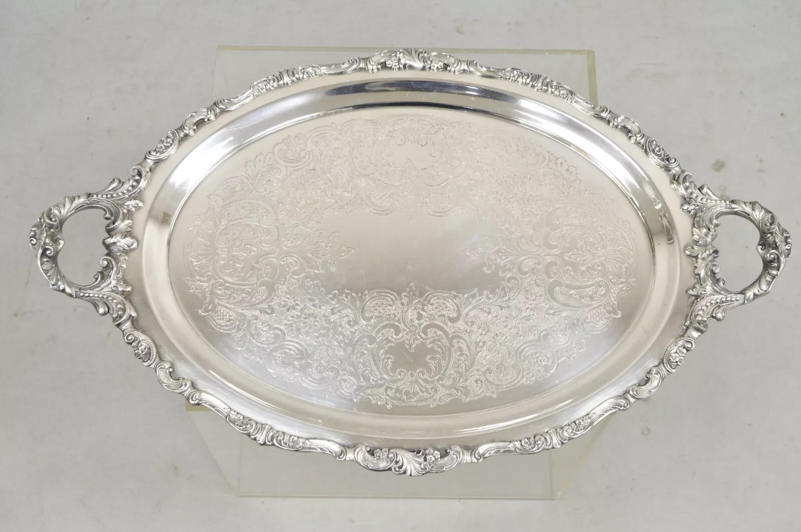 Vintage Baroque by Wallace Oval Silver Plated Victorian Style Serving Platter Tray. Item features ornate handles, nice heavy construction, original hallmark. Circa Mid 20th Century. Measurements: 2