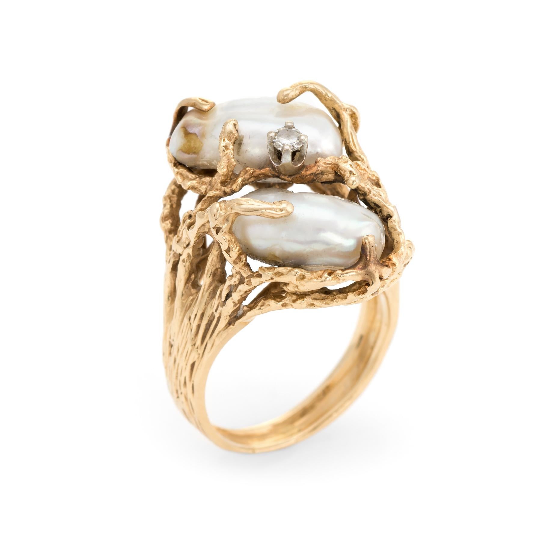 Finely detailed vintage baroque pearl & diamond cocktail ring (circa 1960s to 1970s), crafted in 14 karat yellow gold. 

Baroque pearls measure 13mm x 8.5mm, accented with one estimated 0.05 carat round brilliant cut diamond (estimated at J-K color