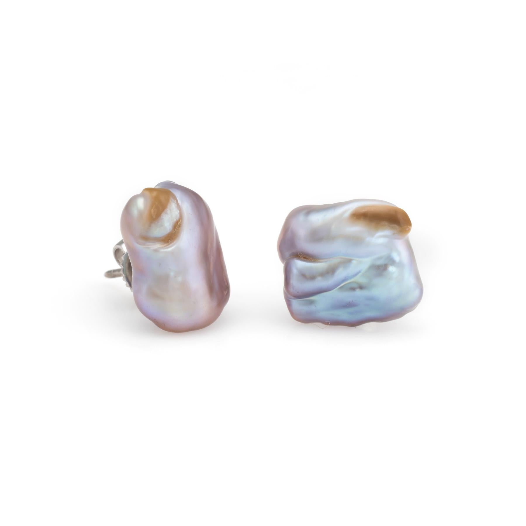 Elegant pair of vintage baroque pearl earrings finished with 14k white gold backings. 

The baroque pearls measure 13mm x 12mm and 15mm x 11mm. The pearls are a soft grey to pinkish color.  

The irregular non-spherical shapes of the pearls add a