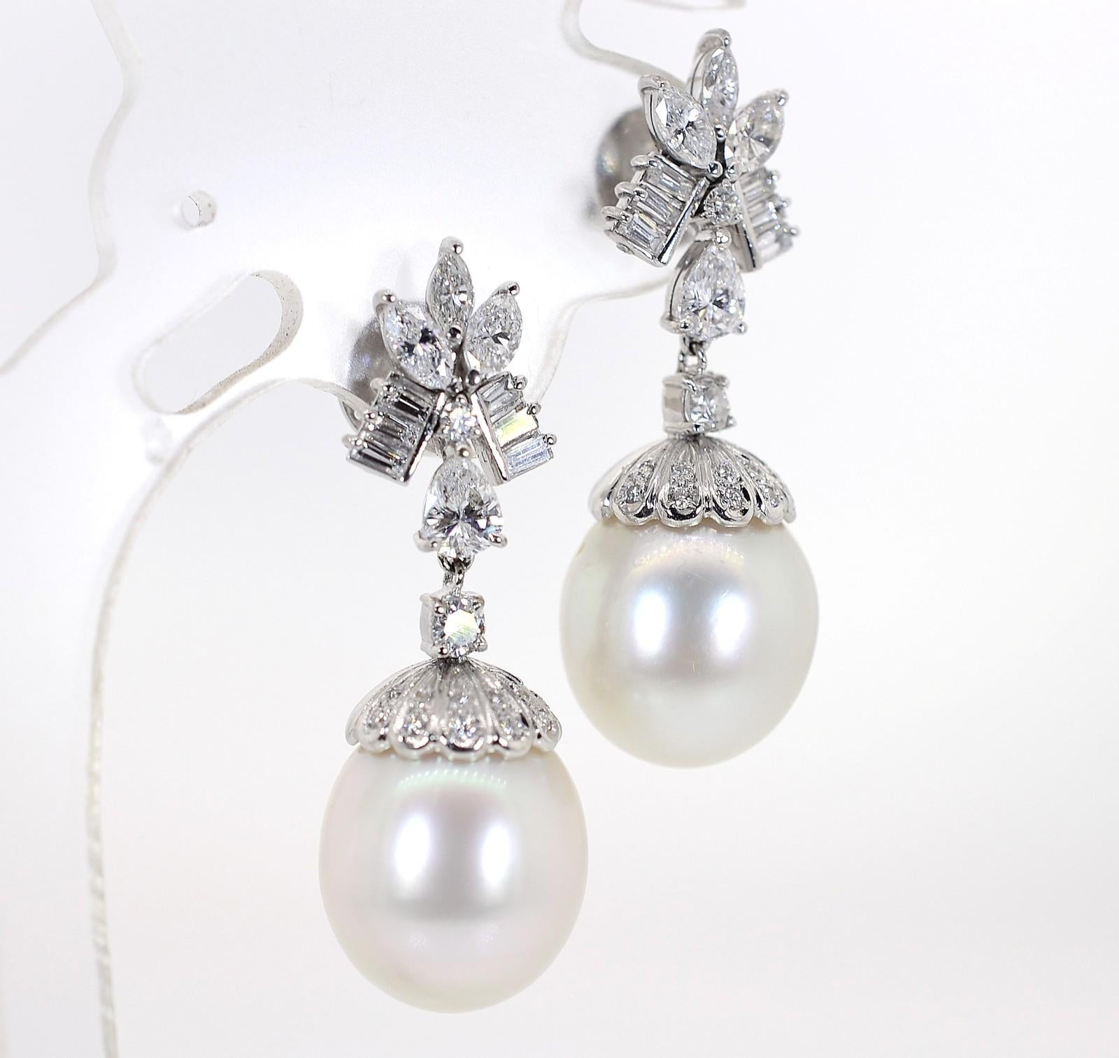 These are the quintessential 1960s Pearl and Diamond earrings. Created in 18KT white gold dangling 2 Baroque Pearls, these pretties have a white creamy undertone and measure 12.50 mm x 14.50 mm. Adorning the top cups are 2.00 carat of shimmering