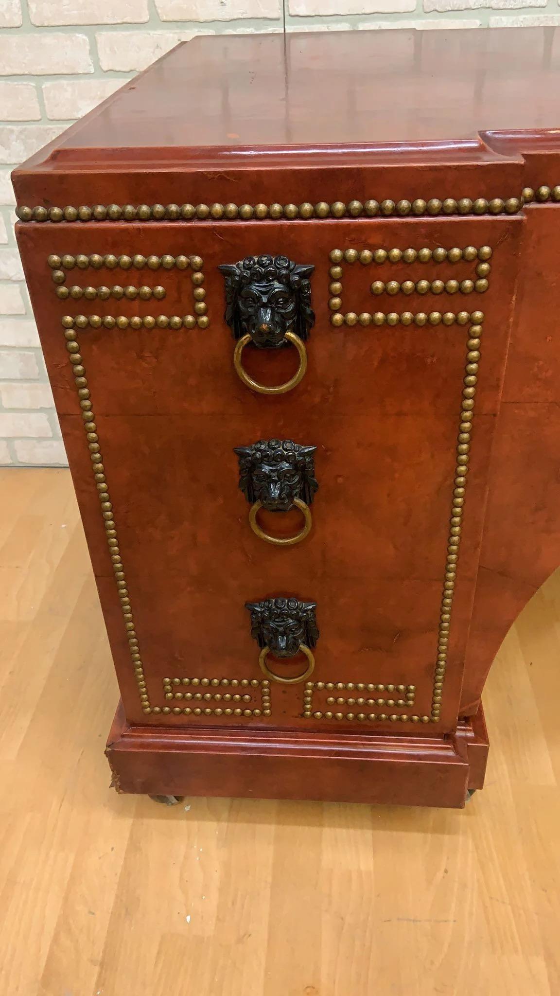 Vintage Baroque Style Leather Wrapped Studded Partner Desk with Lion Pulls

This beautiful, well-made desk has seven drawers on one side and faux drawers on the other. The desk comes complete with all original lion head handles and brown leather top