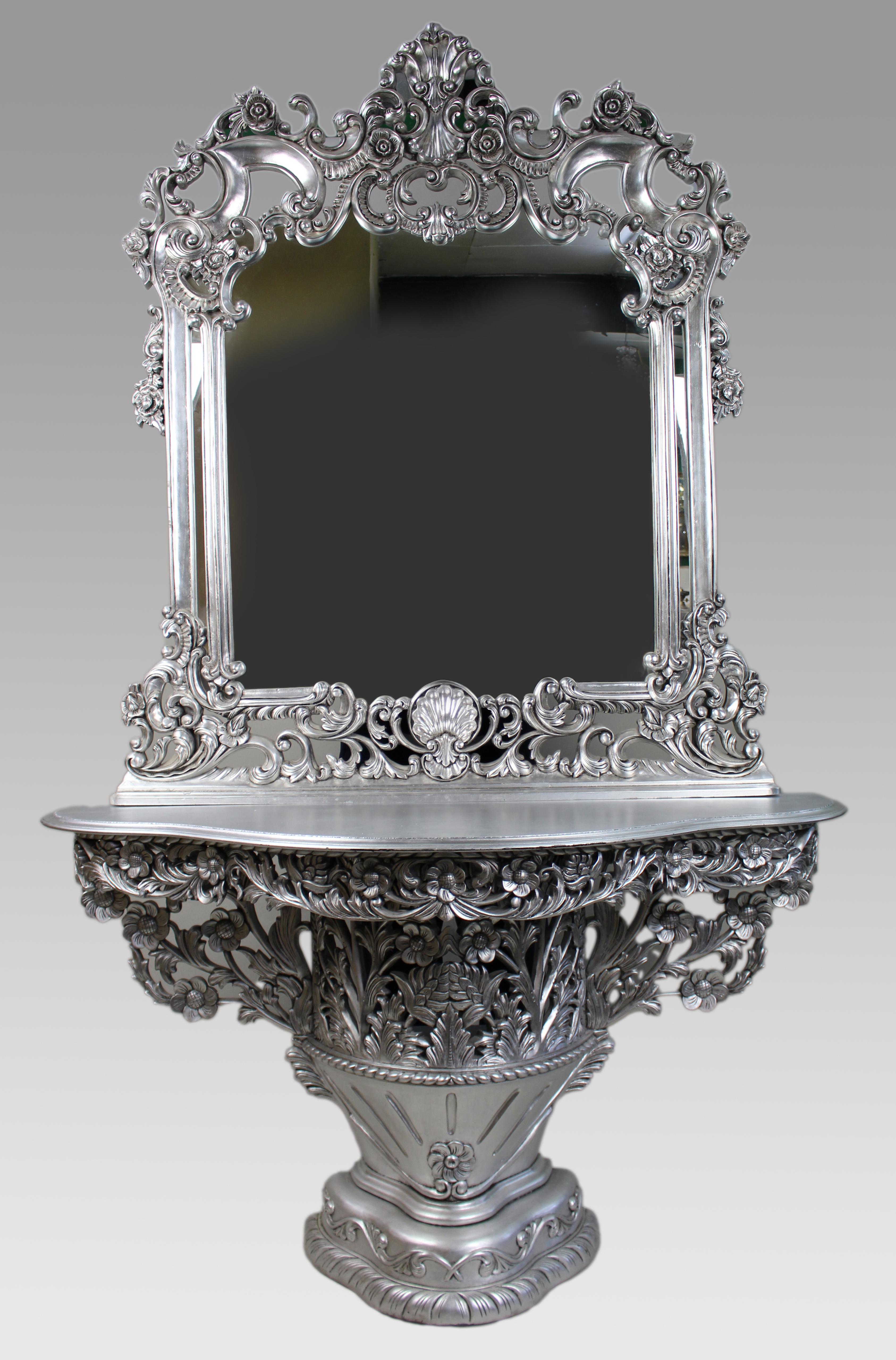 Vintage Baroque Style Silver Leaf Console Table and Mirror

A striking and richly detailed vintage console table with matching mirror, finished in an applied silver leaf. Boldly sculptural in form, the ensemble is executed in the Baroque revival