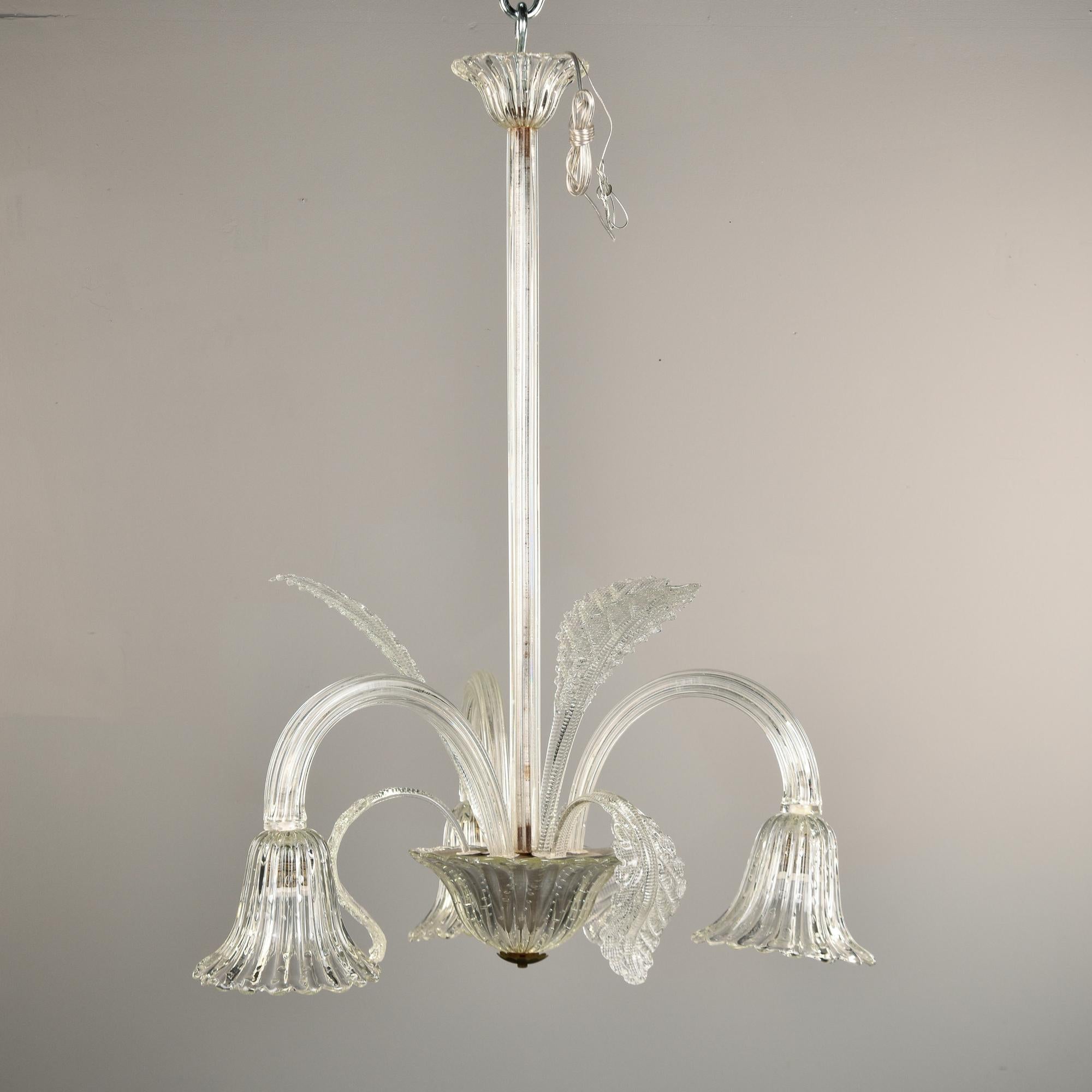 Circa 1940s clear Murano glass fixture with three arms/lights is attributed to Barovier & Toso. Original mouth blown glass ceiling canopy, clear support shaft and three curved arms with downward-facing tulip-form glass bowls with regular sized