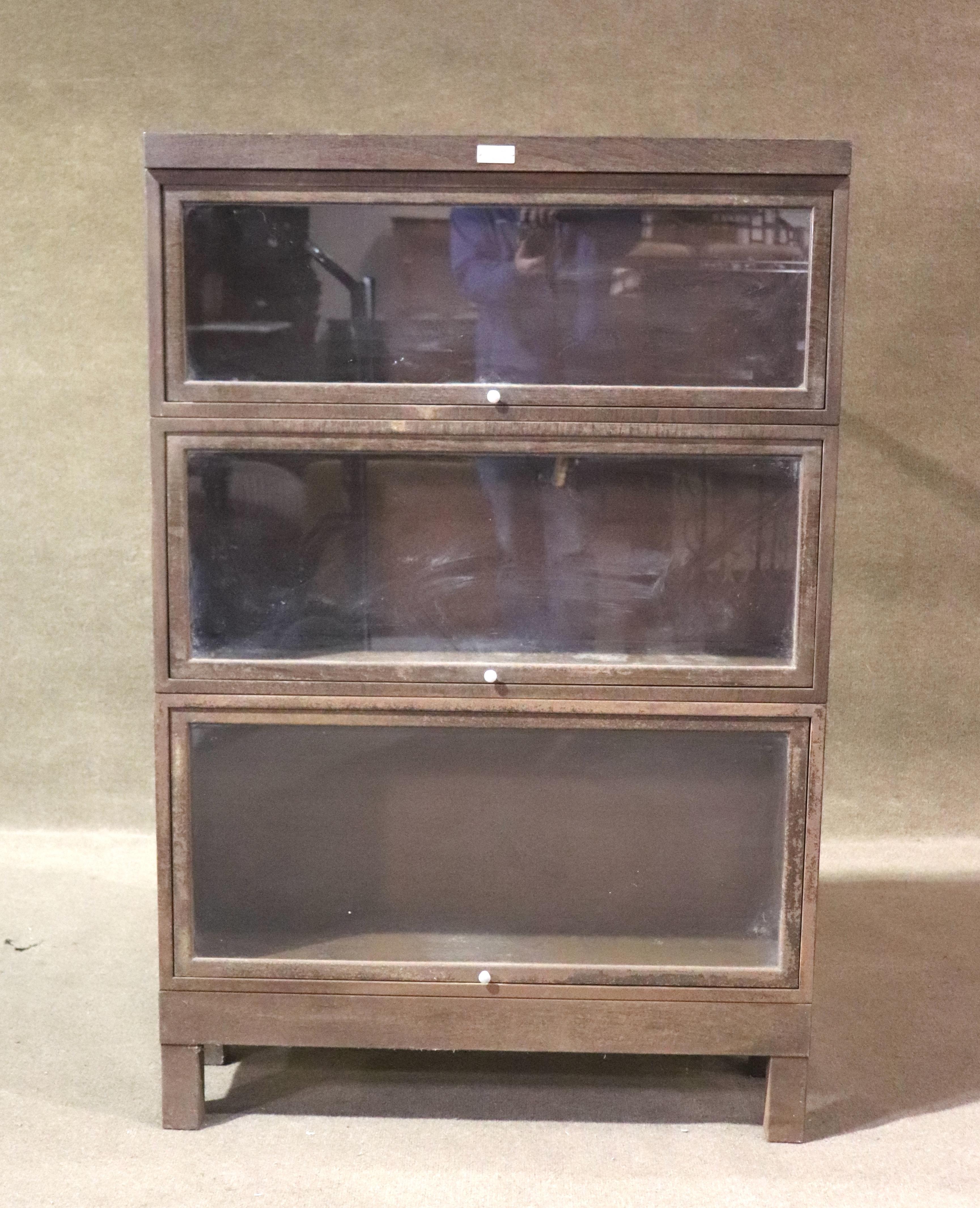 Vintage metal bookcase with receding glass doors. Each of the three units stack on each other with no tools needed. Made originally to house law books, thus given the name of barrister bookcase.
Please confirm location NY or NJ