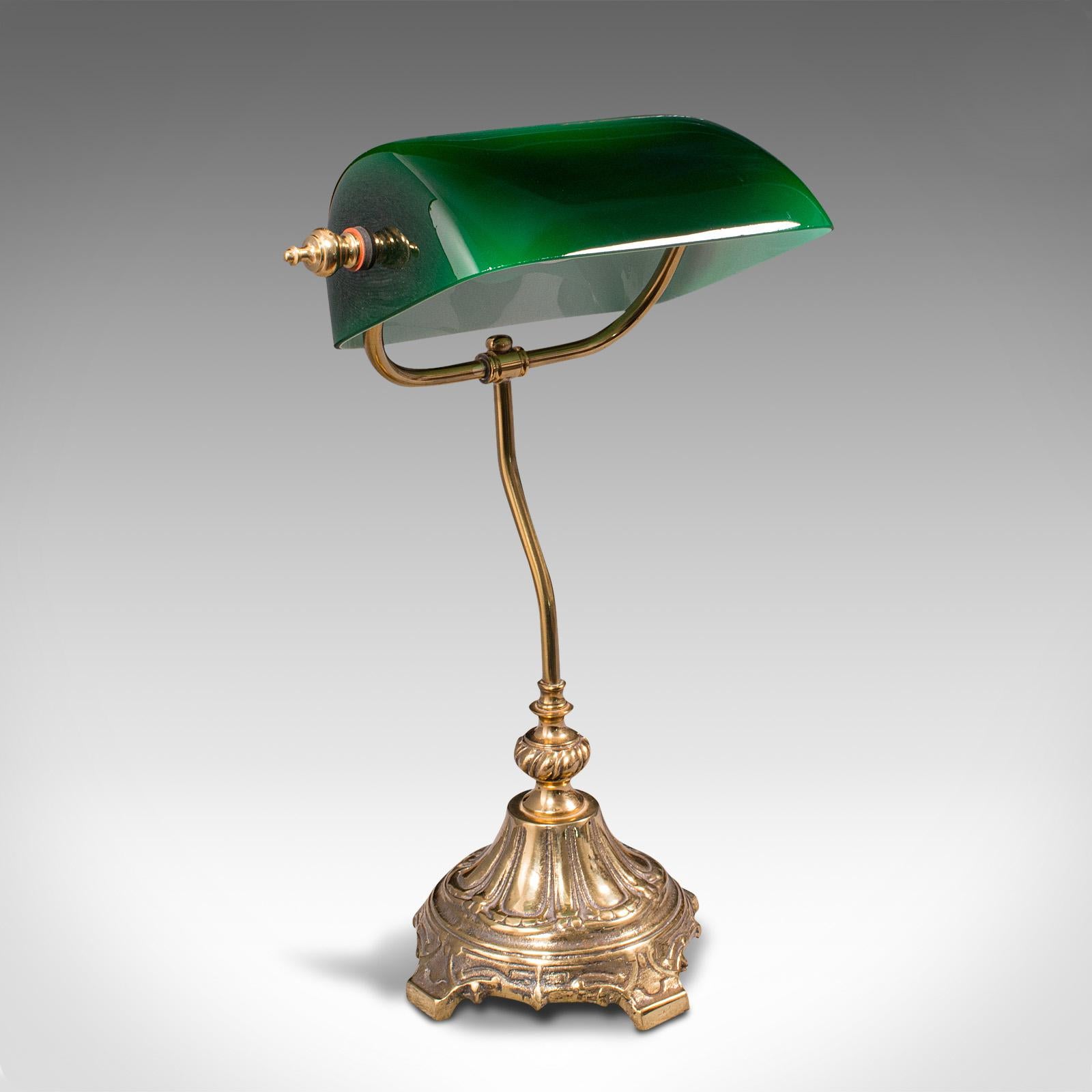 This is a vintage barrister's lamp. An English, glass and brass adjustable banker's desk light, dating to the mid 20th century, circa 1960.

Delightful example, with the executive appeal suited to the grandest desks
Displays a desirable aged