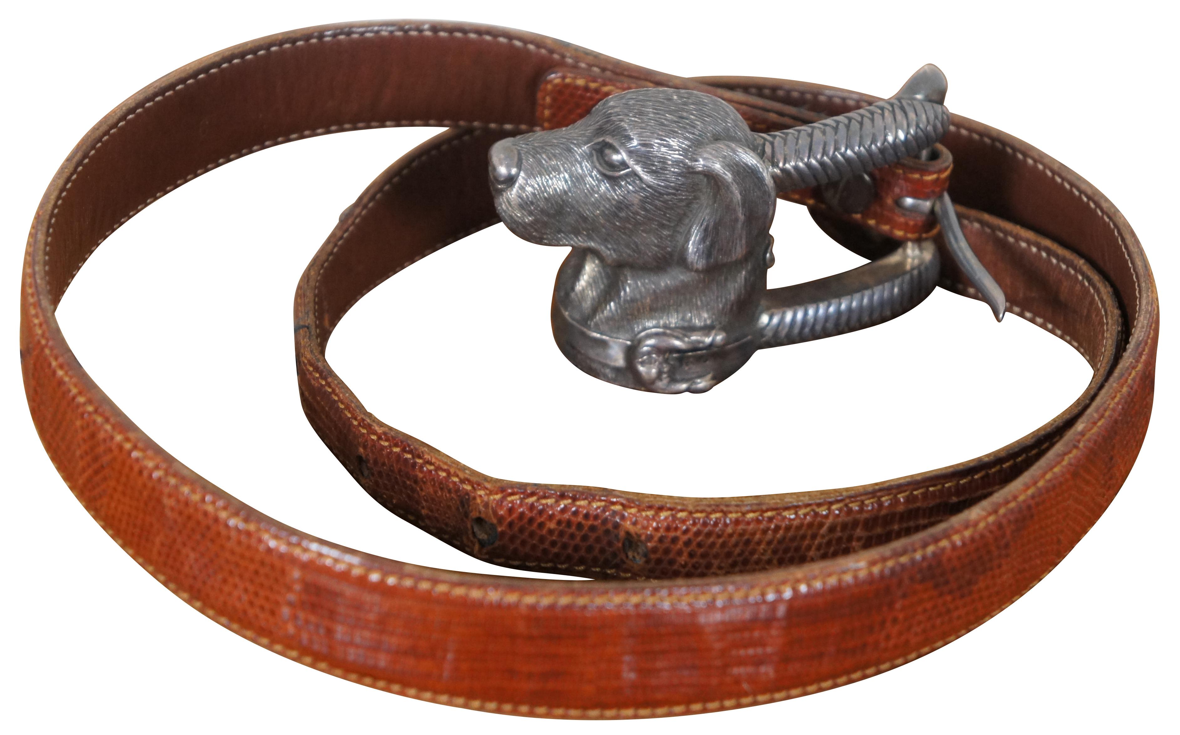 Vintage Barry Kieselstein-Cord brown genuine lizard skin belt with sterling silver buckle in the shape of the head of a Labrador wearing a collar decorated with a Man in the Moon, number 327, circa 1989.

Measures: 39” x 1” / Fits - 27.5” to 31.5”