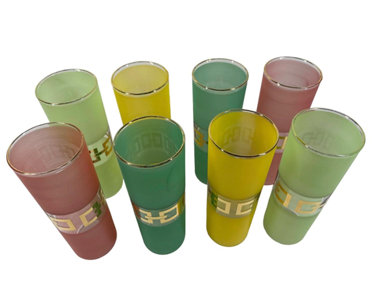 Set of eight Mid-twentieth century Tom Collins glasses, two each of four colors, lime, yellow, teal and red. Each glass frosted top and bottom with a central band left clear, which is then decorated with 22 karat gold in a stylized chain-link