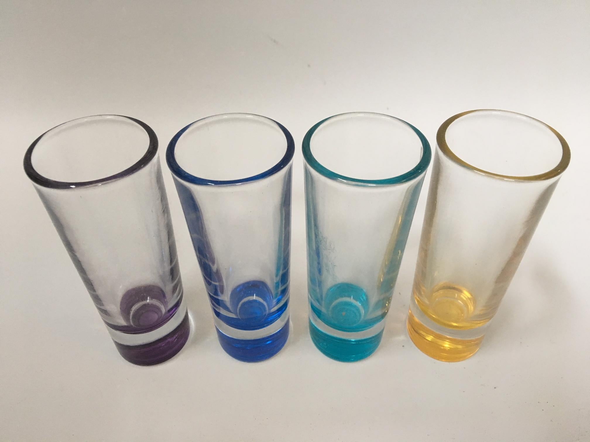 Set of 4 vintage shot glasses in assorted colors. Very good condition.