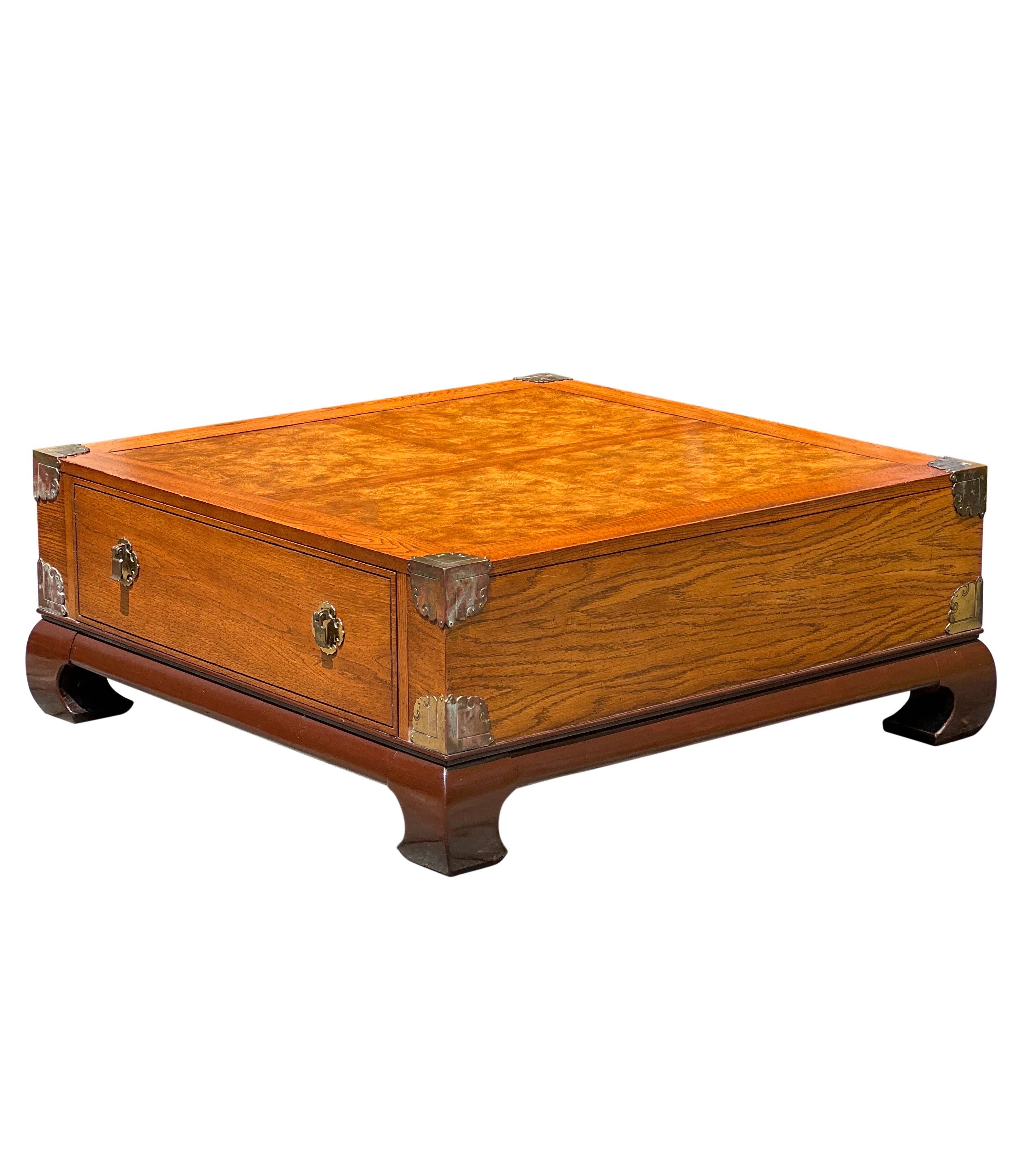 Vintage Bassett Asian style burl coffee table with brass accents, 1970s.

This impressive table is adorned with chunky brass corner accents with great patina and a beautiful burl top. It features a large, single dovetailed drawer in clean condition