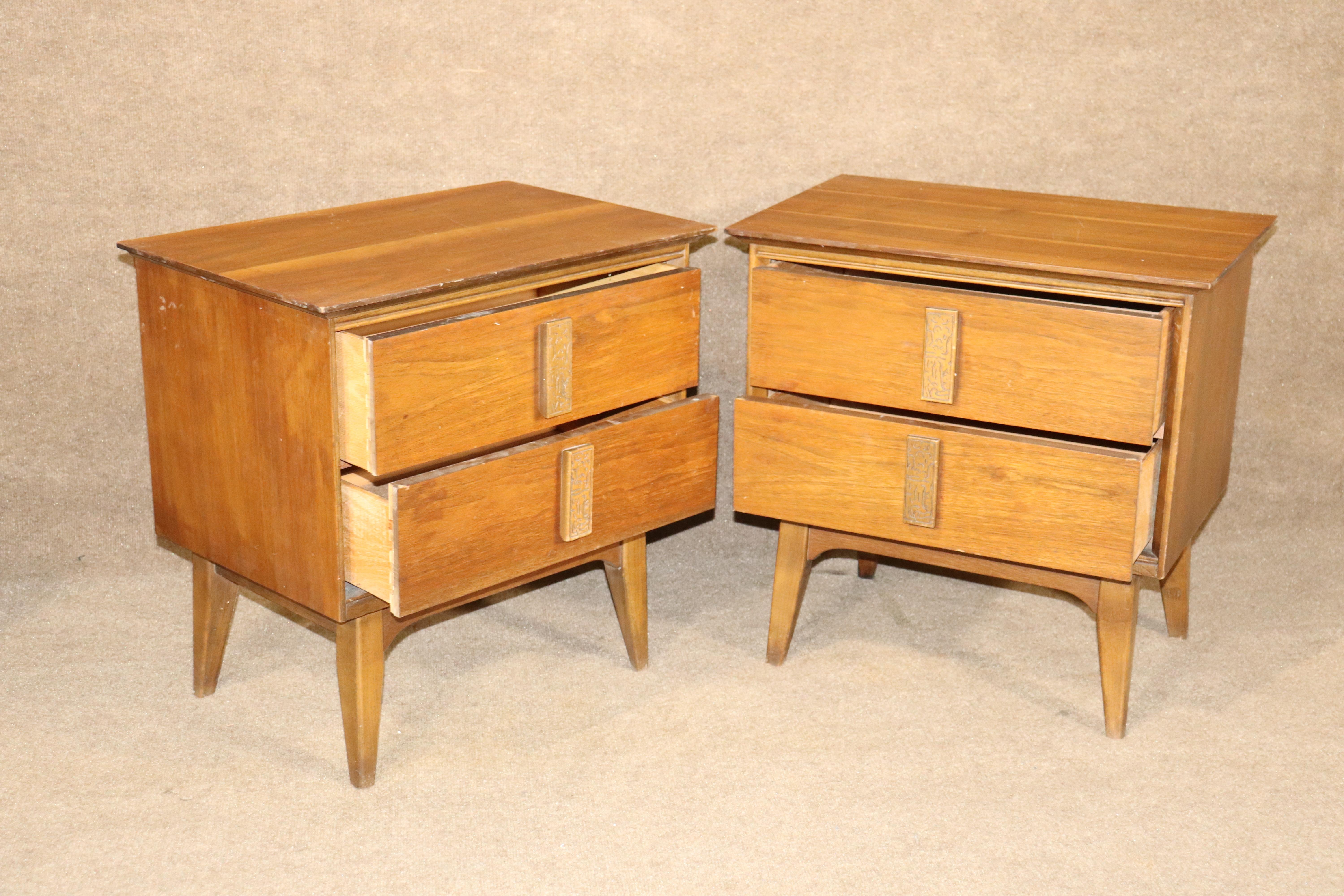 Pair of mid-century walnut tables by Bassett for their 'Mayan' collection. Two drawers for bedside storage, each with carved handles.
Please confirm location NY or NJ.