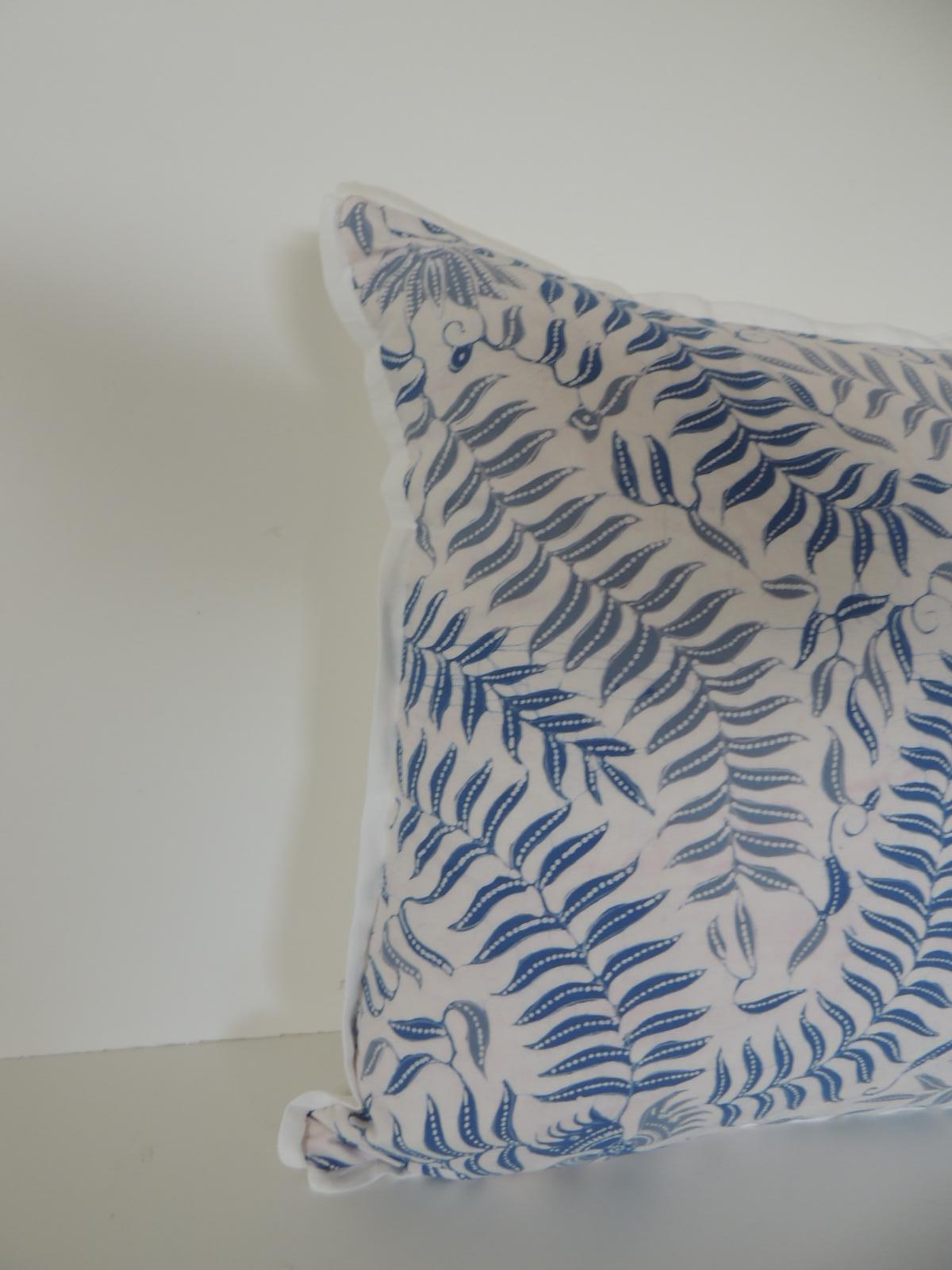 Petite square floral blue and white throw pillow depicting birds and fern in the front textile. Throw pillow in light and dark shades of blue. Pillow embellished with ATG custom white cotton flat trim all around. Decorative bolster pillow finished
