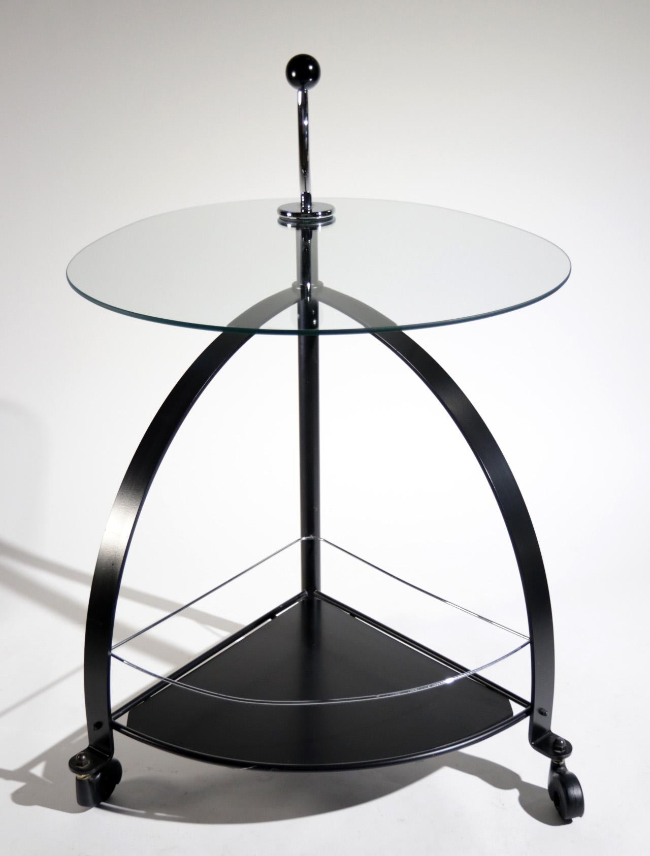 Very nicely designed serving trolley from circa 1980s.
Made of black coated flat steel, chromed steel parts and glass top.   
   