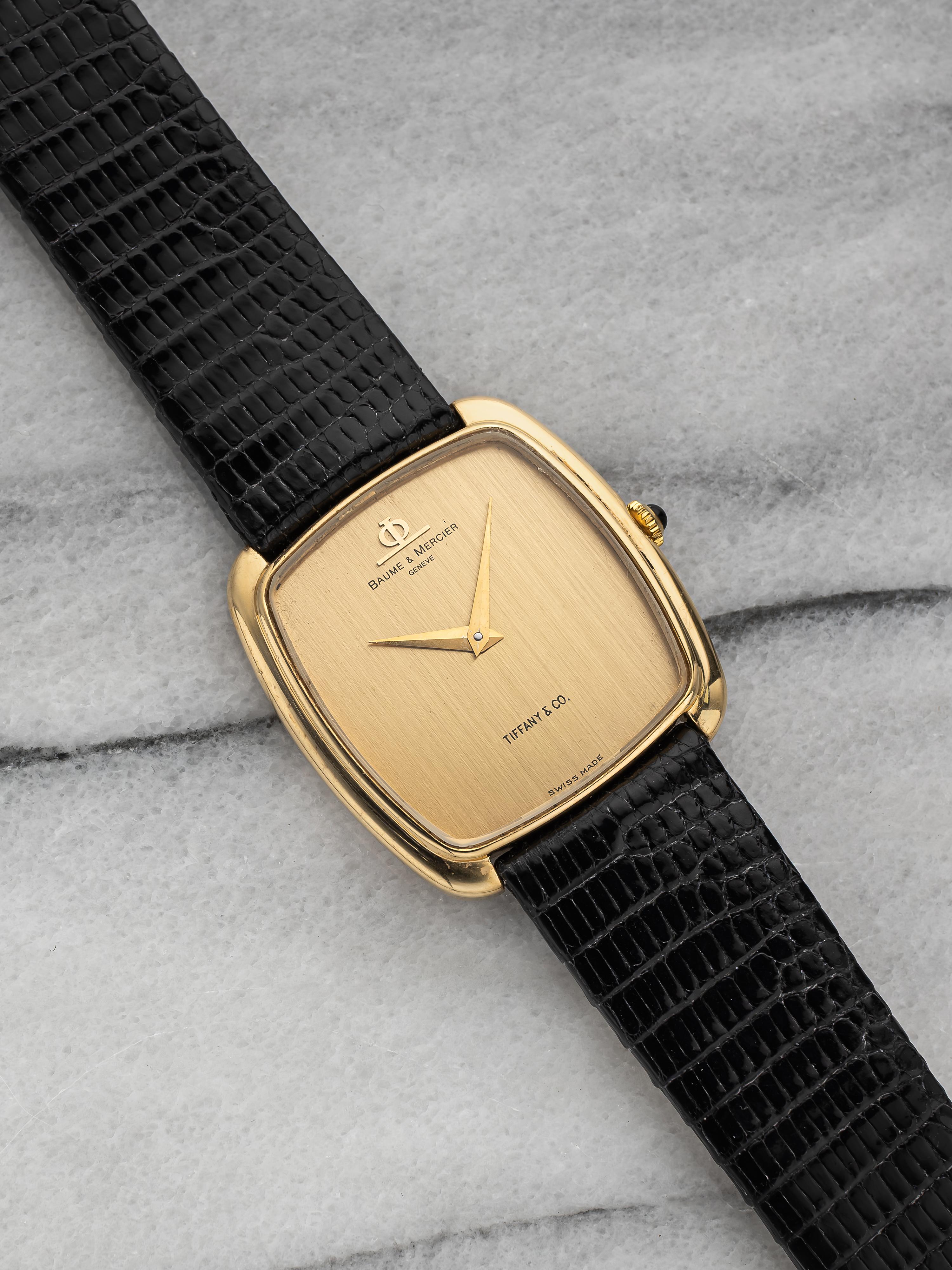 Here's a vintage Baume 
Mercier in 18k yellow gold manual wind with a champagne Tiffany 
Co stamp a 6 aclock from the 1970s.  It keeps great time and is fully functional. Measurements include a 25x34mm case and 18mm lug width. On an