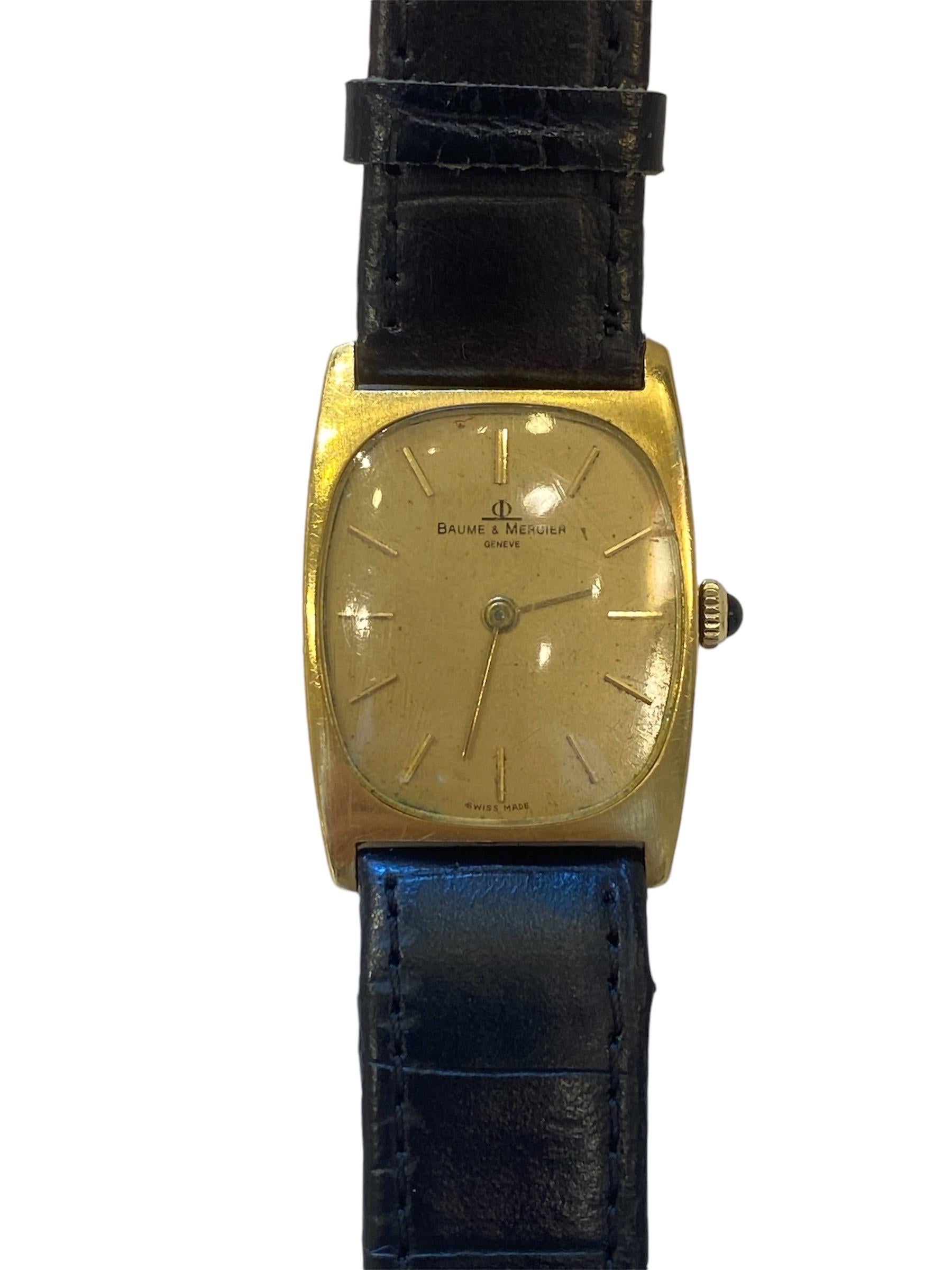 Description 

Vintage Baume & Mercier Gold-Plated Tonneau Watch with Black Leather Strap

This is an elegant vintage Baume & Mercier watch, featuring a stylish tonneau-shaped gold-plated case and a black leather strap with a crocodile texture. The