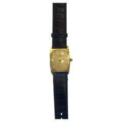 Montre vintage Baume & Mercier plaquée or avec bracelet en cuir noir