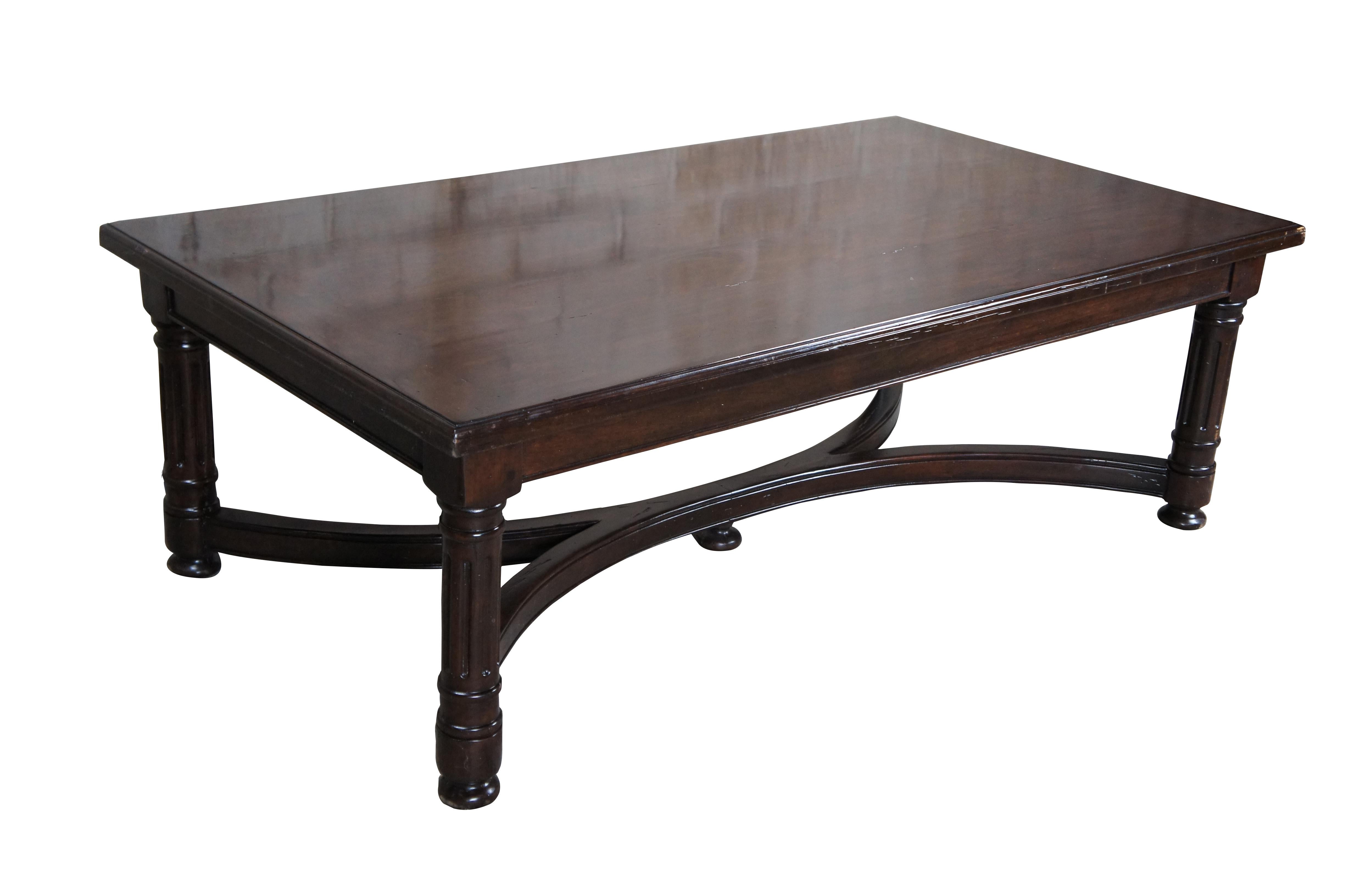 A benchmade coffee table by Bausman & Co. out of Califronia.  Features a mitered plank top, curved stretcher and bun feet.  Naturally distressed with fluted legs.  Finished in walnut

Dimensions:
54