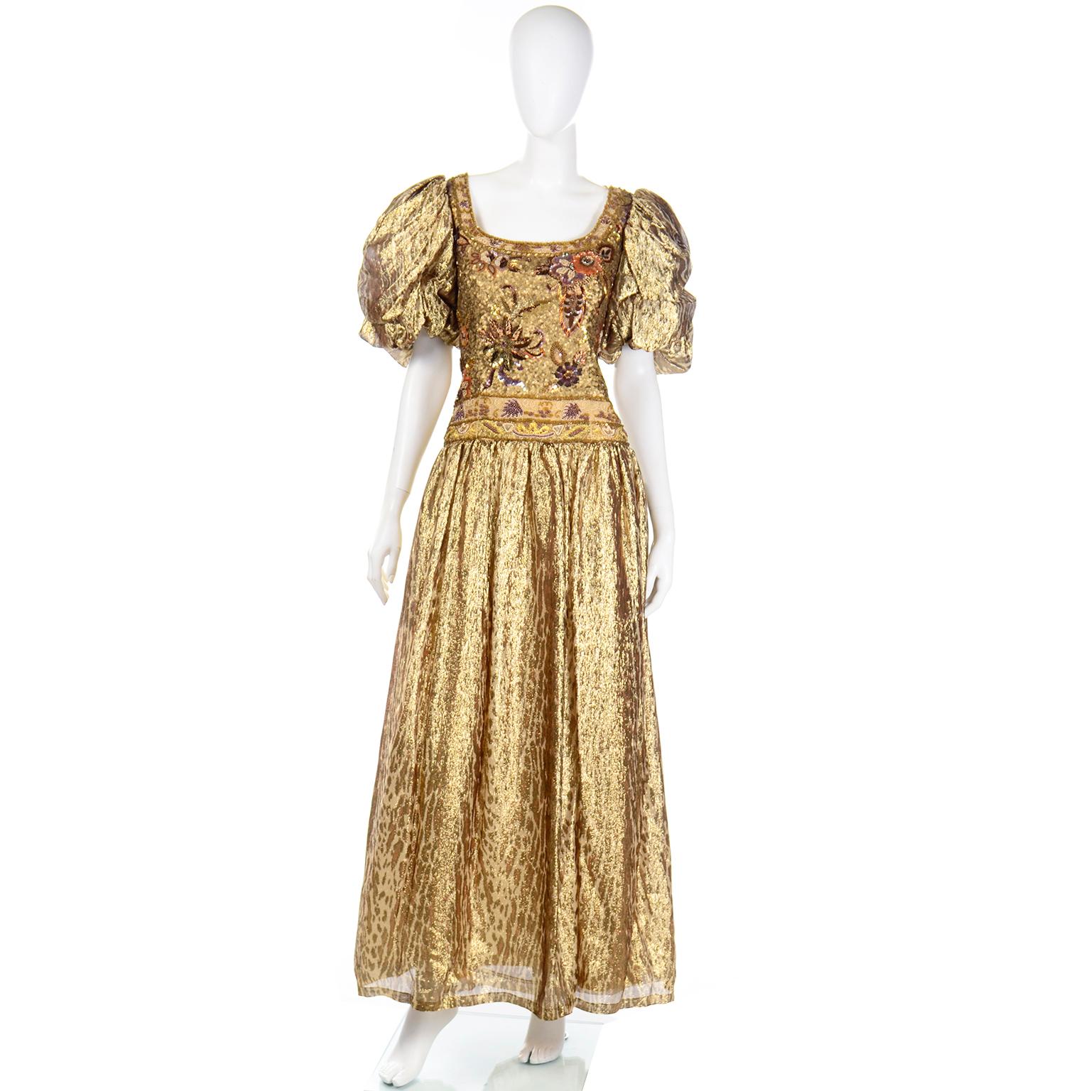 This is a stunning 1980's vintage Richilene New York beaded evening dress in a beautiful metallic gold tissue silk. The skirt and sleeves of the dress are a in a tonal gold leopard print and the bodice is covered with gorgeous beadwork and sequins