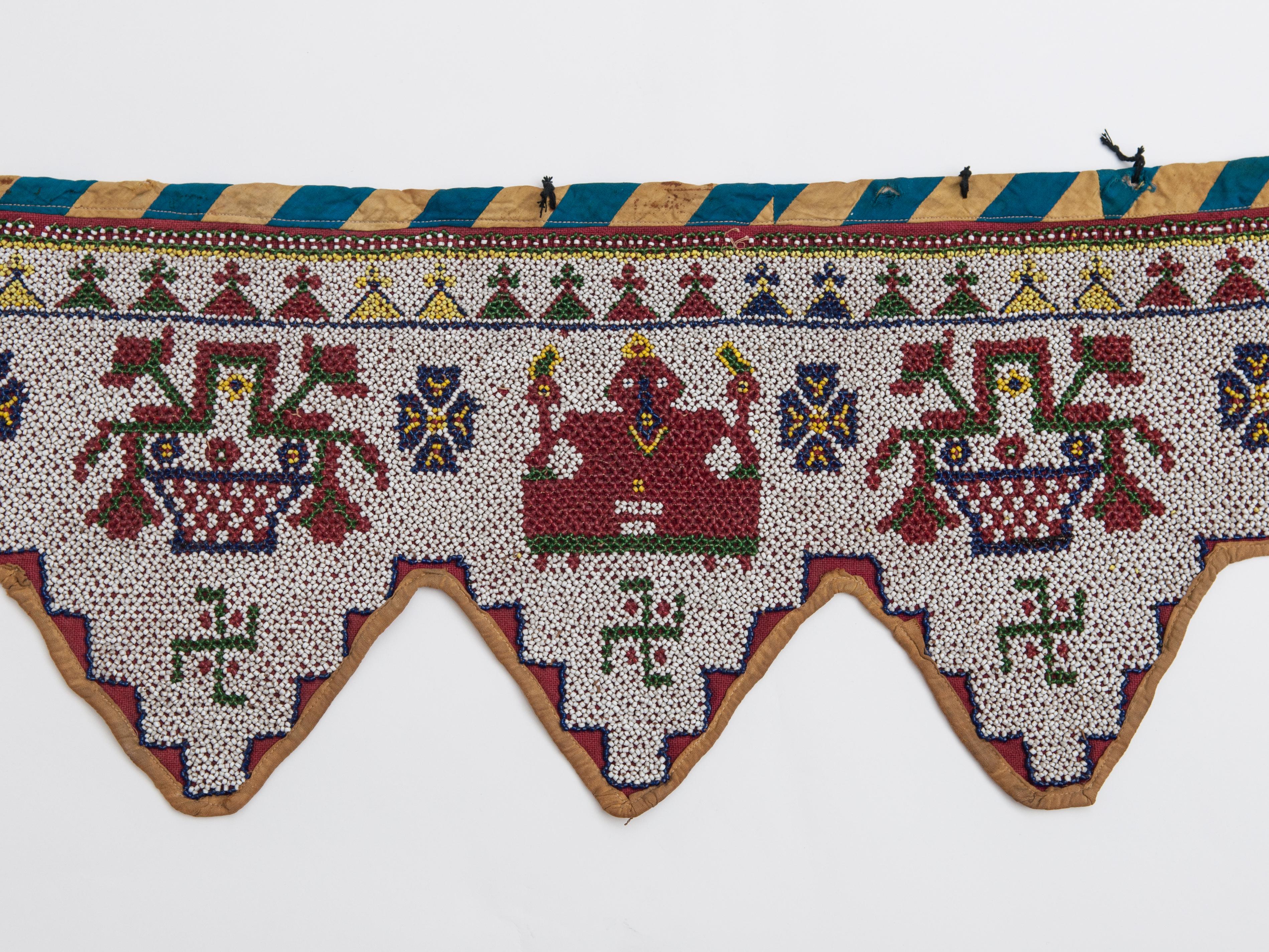 Vintage Beaded Toran doorway hanging. Kathi of Gujarat, India, mid-20th century.
Beadwork was introduced into Gujarat in the mid-1800s when Indian traders based in Zanzibar began trading Venetian beads into India. By the 1900s, the women of