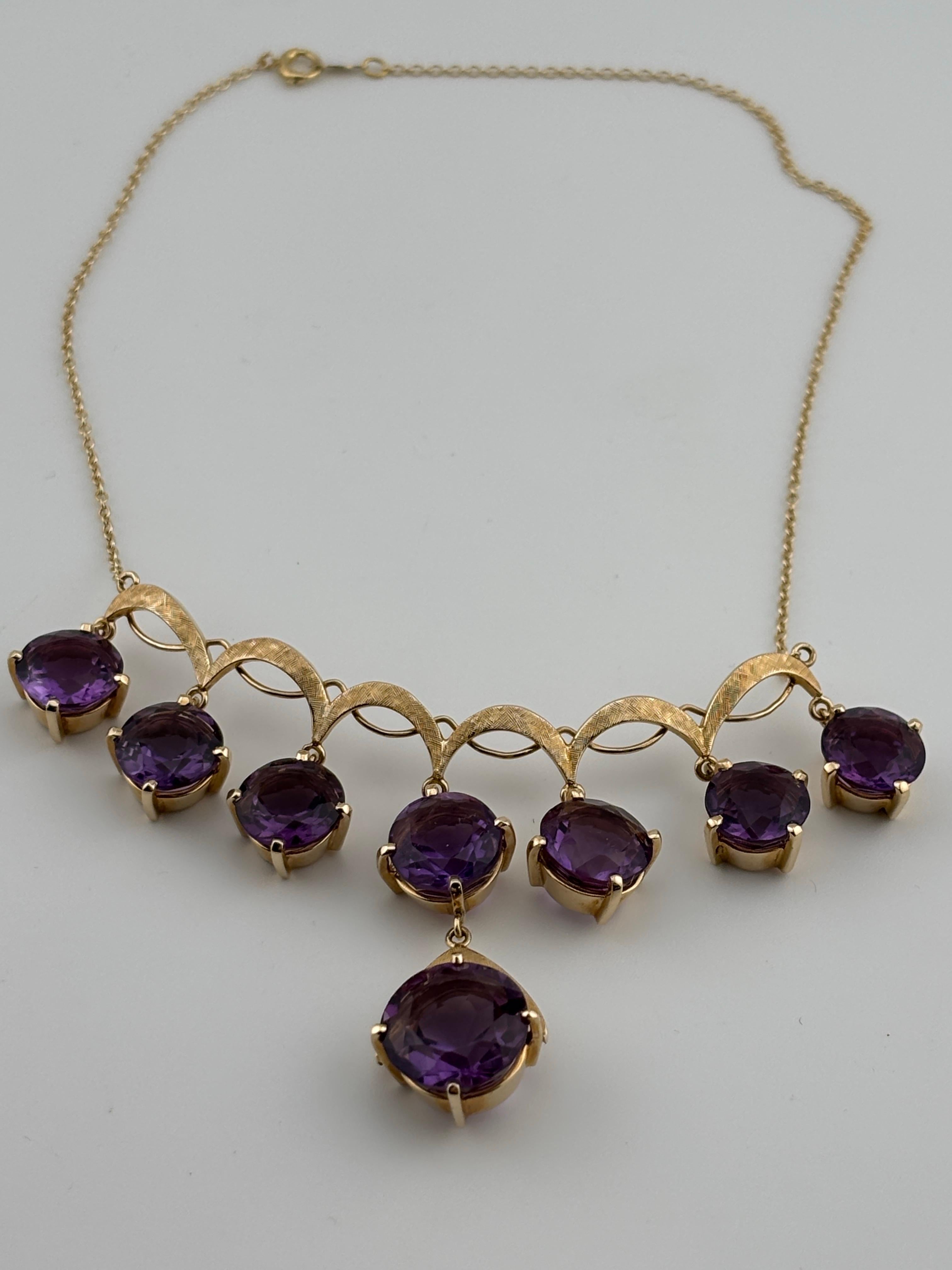 This elegant 14k gold drop necklace features a striking amethyst gemstone that exudes vibrant purple hues. Set in a delicate gold settings, the amethysts are suspended gracefully, allowing it to catch the light from every angle. The rich color of