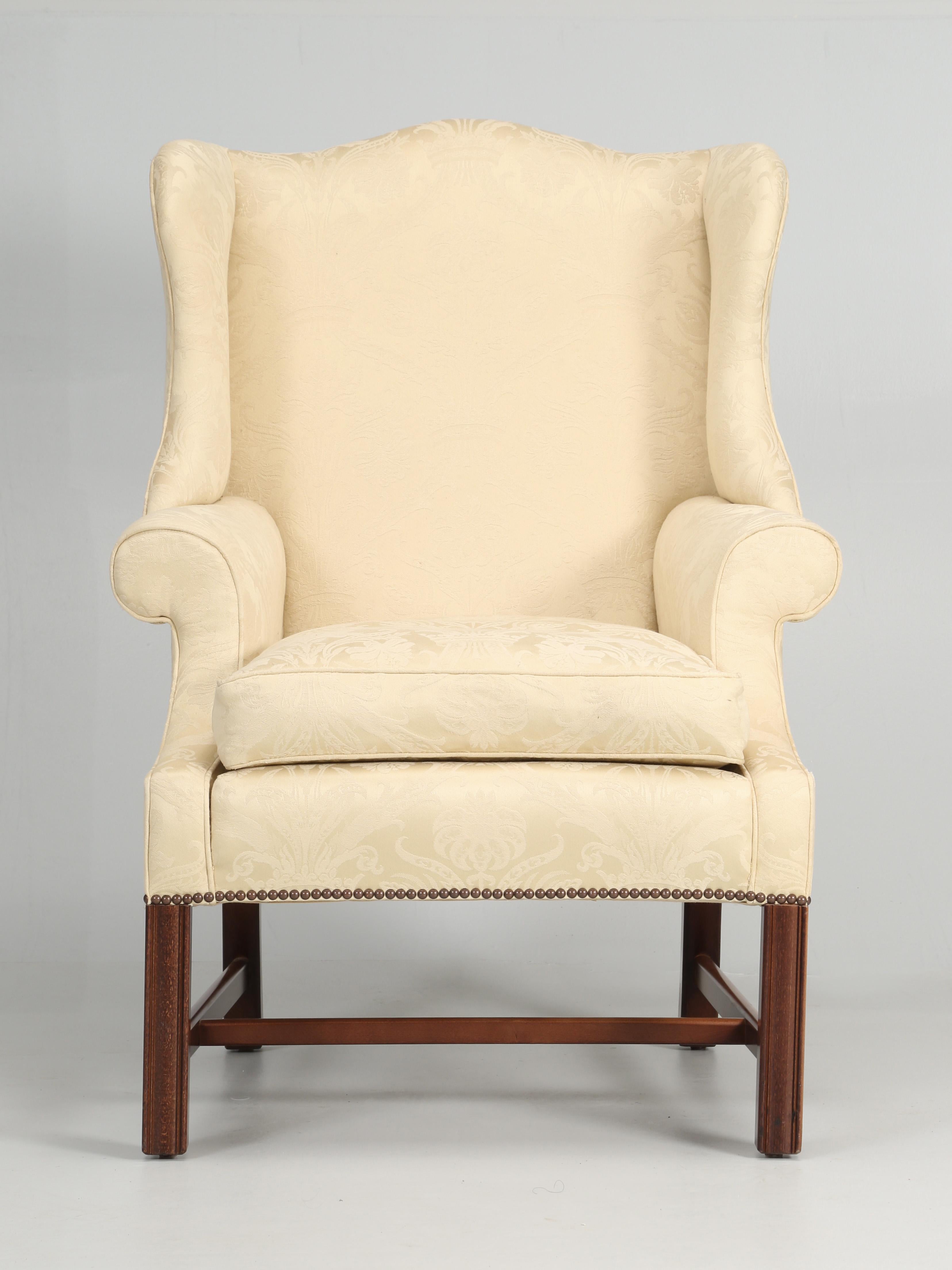 Hand-made English Chippendale style wingback chair of a high quality. The seat cushion is filled with down feathers, as one would expect in a quality wingback and we are guessing that the fabric is original and beginning to show its age. Extremely