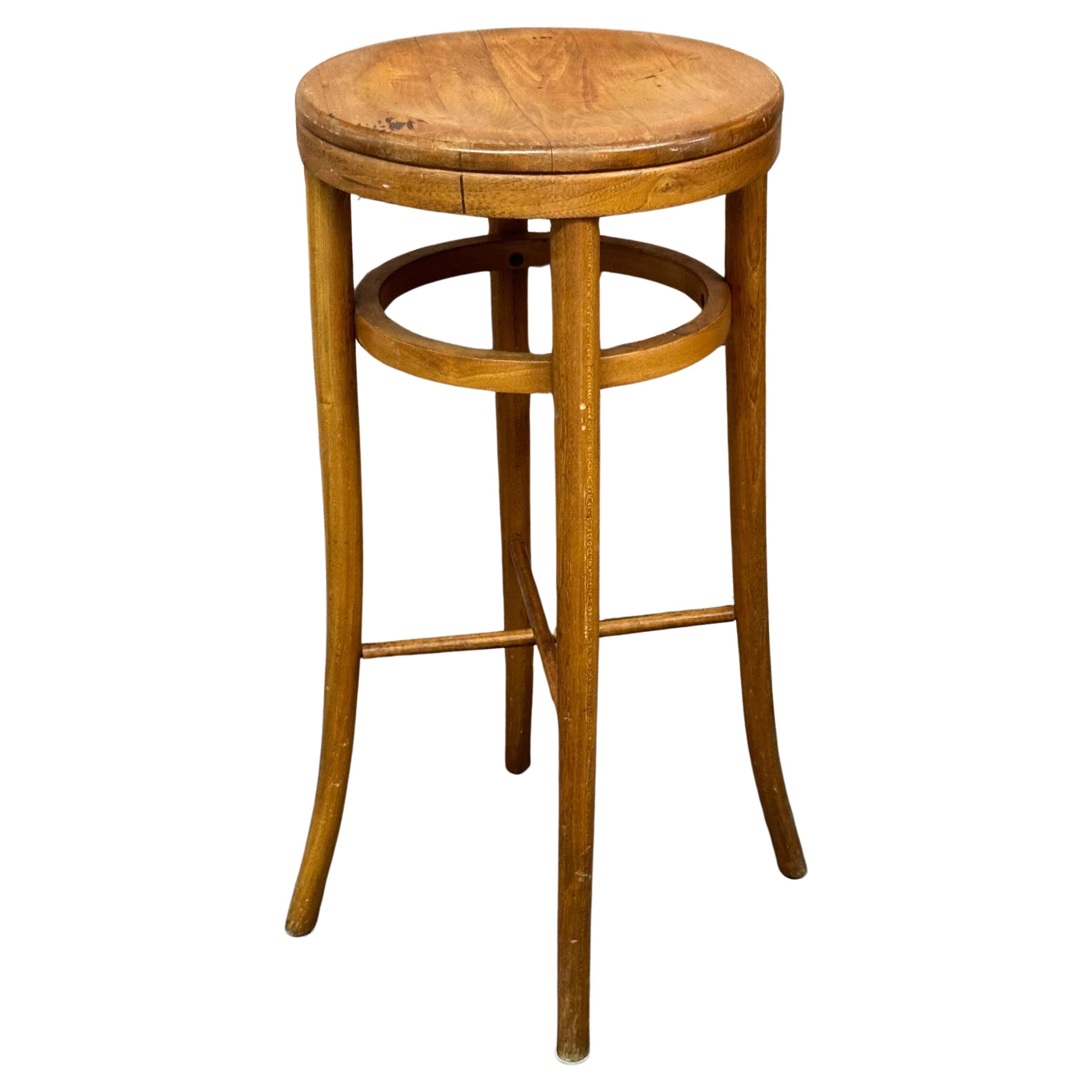 A vintage beech bentwood stool by Thonet Industries with original label, circa 1940s.  The stool is in good vaintage condition showing appropriate wear and patina.  It measures 14.5