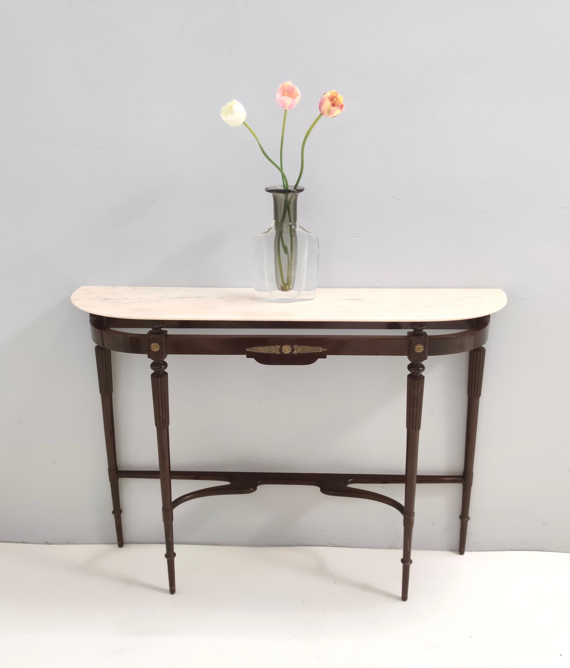 Made in Italy, 1960s.
It features a beech frame, brass parts and a Portuguese pink marble top.
It might show slight traces of use since it's vintage, but it can be considered as in excellent original condition and ready to become a piece in a home.