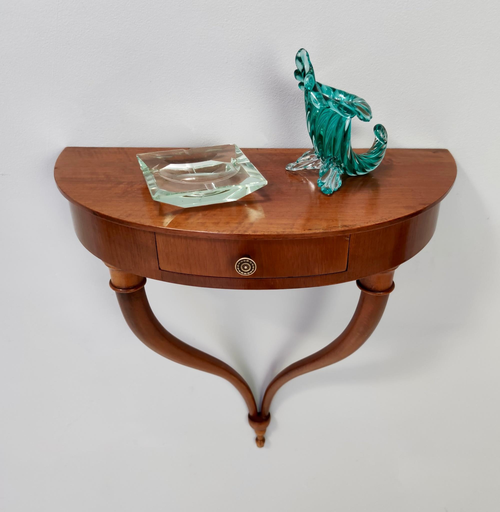 Made in Italy, 1940s. 
This wall-mounted console table are designed by Guglielmo Ulrich, and features a beech frame and a drawer with green velvet interior and a brass handle. 
It might show slight traces of use since it's vintage, but it can be