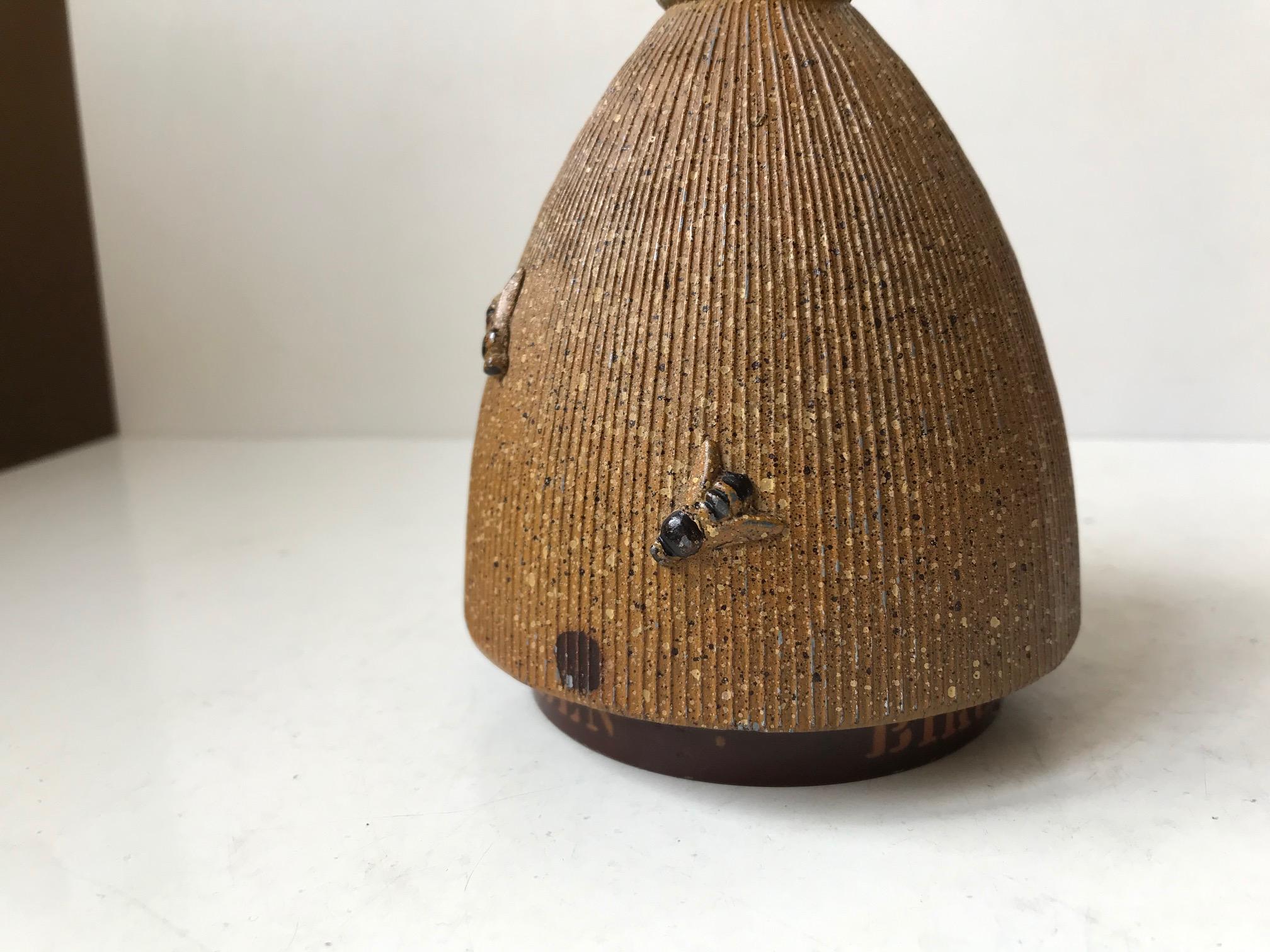 Well made money bank in painted iron. It features an insert for both coins and notes. It decorated with fixed bees also made from metal. It is titled Bikuben to its bottom. Bikuben means Beehive and it was actually made by a Danish Bank by that name