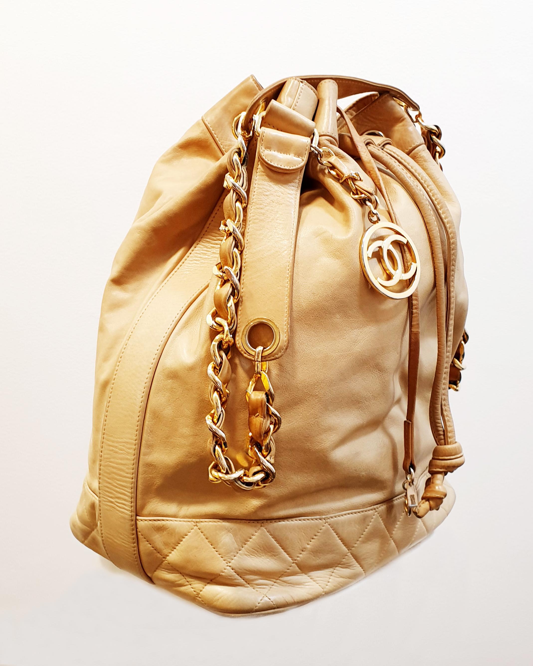 Vintage Beige Caramel Chanel Large drawstring bag lambskin with gold metal 
Lambskin & Gold-Tone Metal
Height * Lenght  35 x 33cm /14 x 15 inches 
Shoulder Belt 105cm / 41,33 inches

Absence of vulgarity was central to Chanel’s definition of luxury,