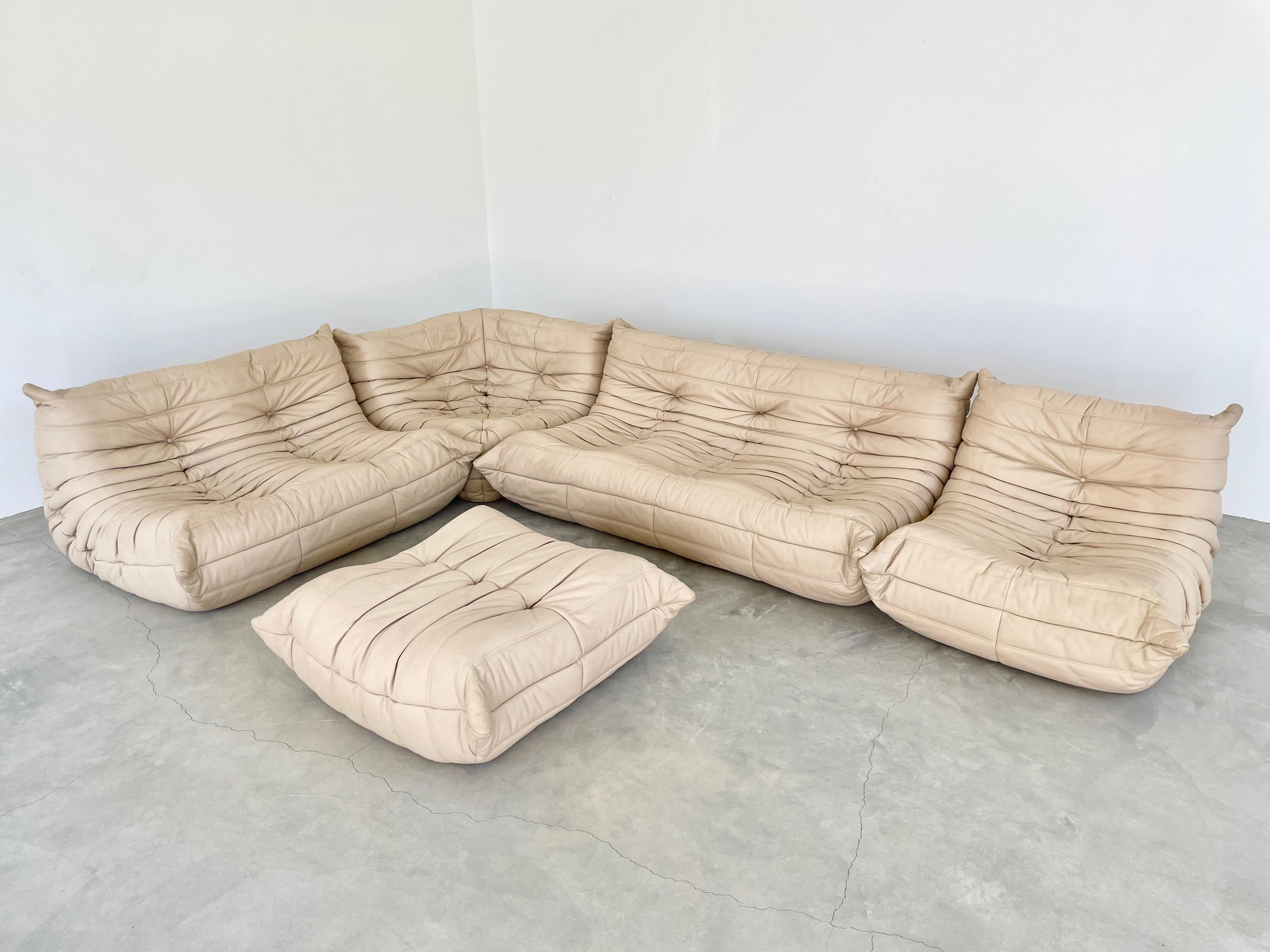 Classic French Togo set by Michel Ducaroy for luxury brand Ligne Roset. Originally designed in the 1970s the iconic togo sofa is now a design classic. This set comes in its original beige leather.

Timeless comfort and style make this monumental