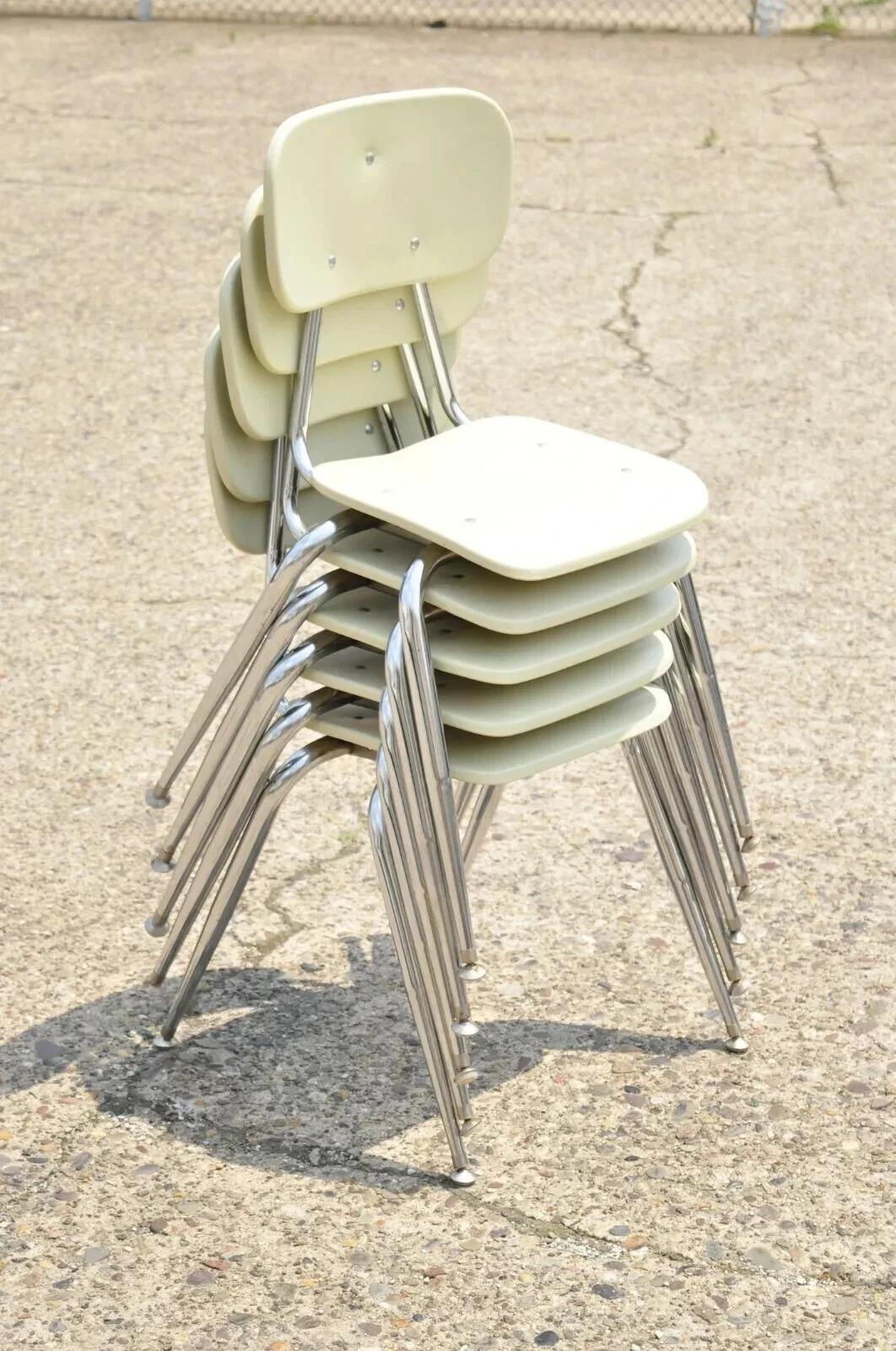 Vintage Beige Molded Plastic Chrome Metal Base Stacking School Side Chair - Single. Item features molded plastic back and seat, metal legs, stacking form, beige finish, quality American craftsmanship. Circa Late 20th Century. Measurements:  32.5