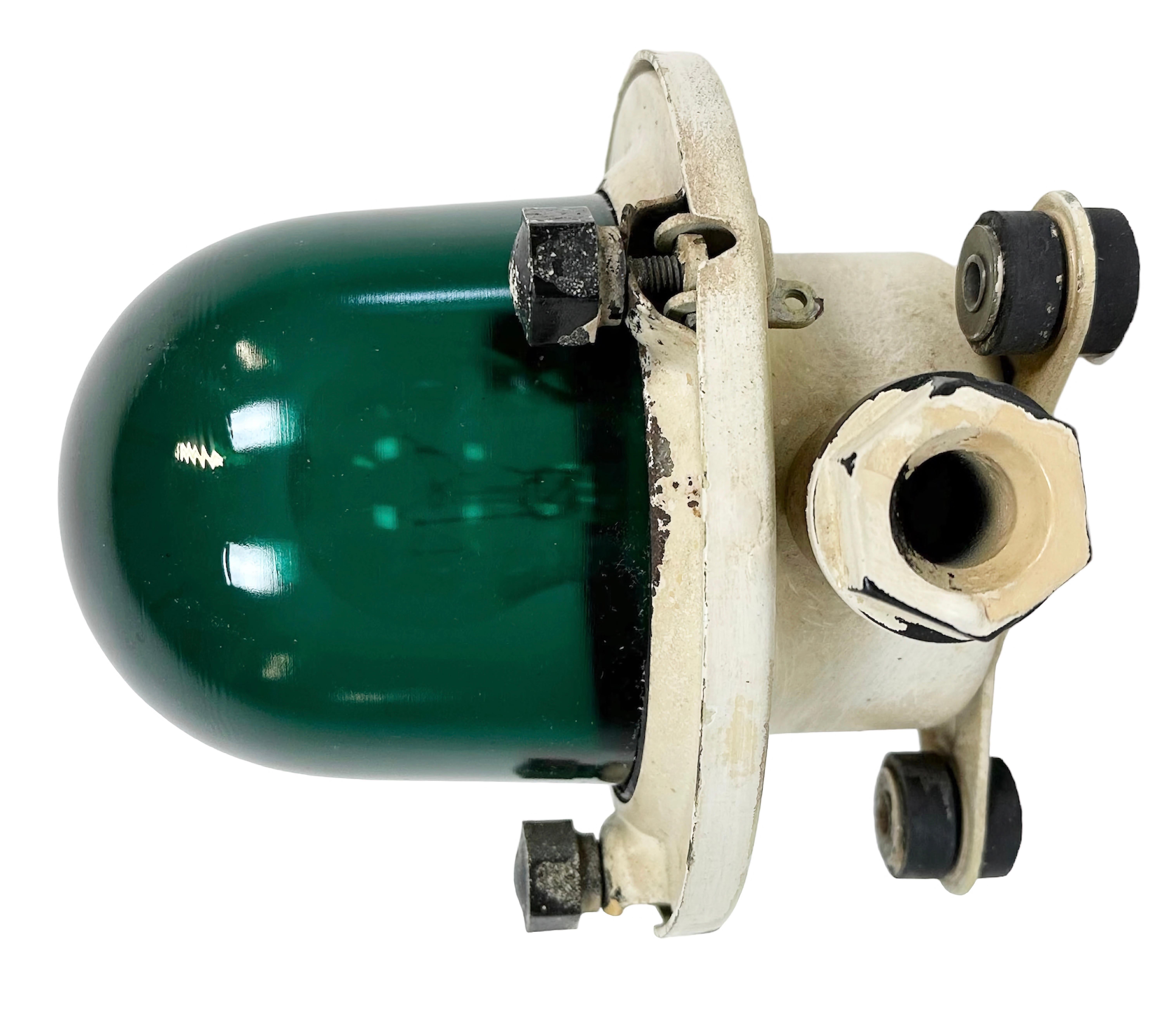 Vintage industrial celing or wall light made in former Soviet Union during the 1960s. It features a beige metal body and a green glass cover. The socket requires E 27/ E 26 light bulbs. New wire. The diameter of the lamp is 17cm. The weight of the